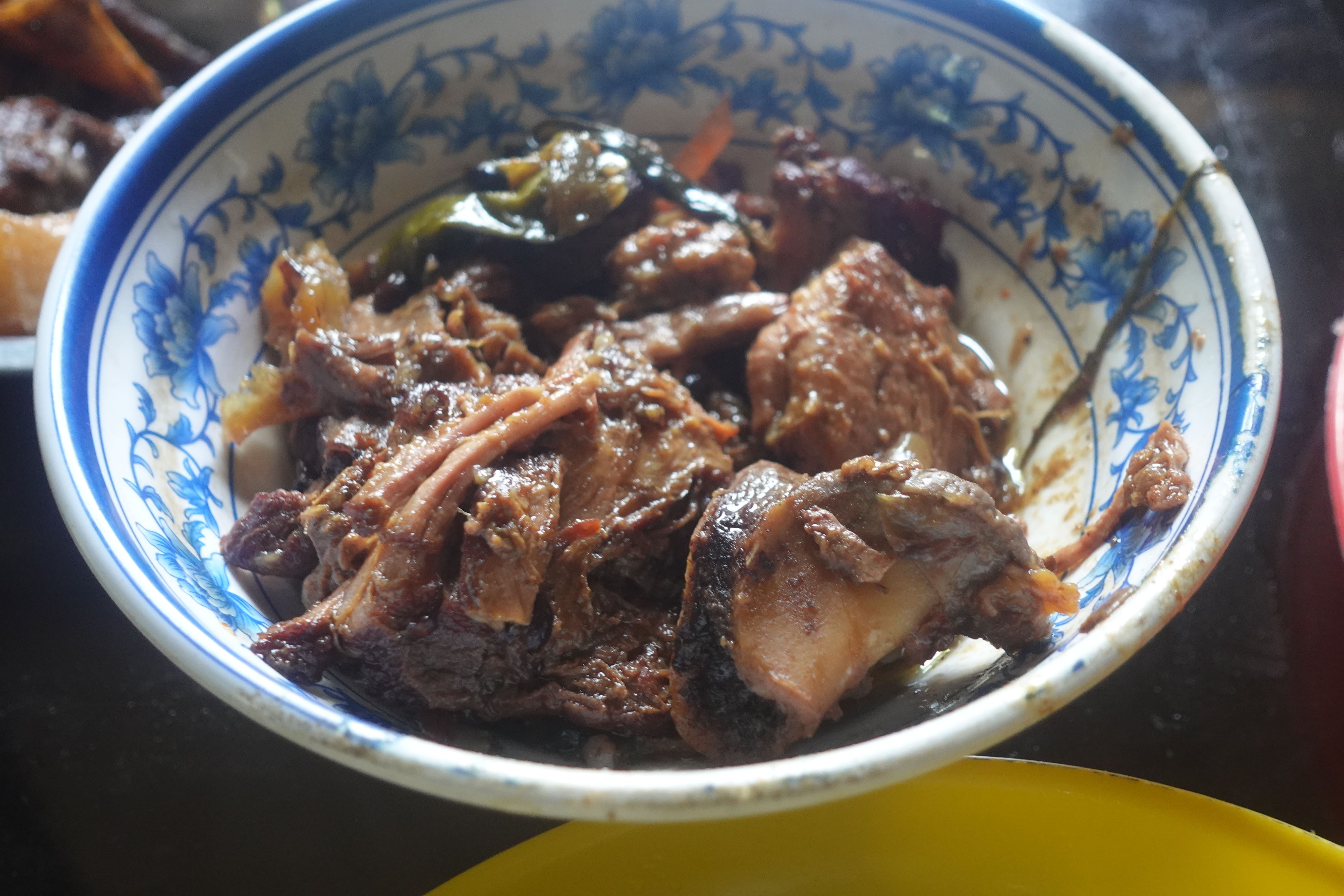 Lechon paksiw simmering in a pot the morning after a barangay fiesta in Can-ibuang, Catmon, Cebu