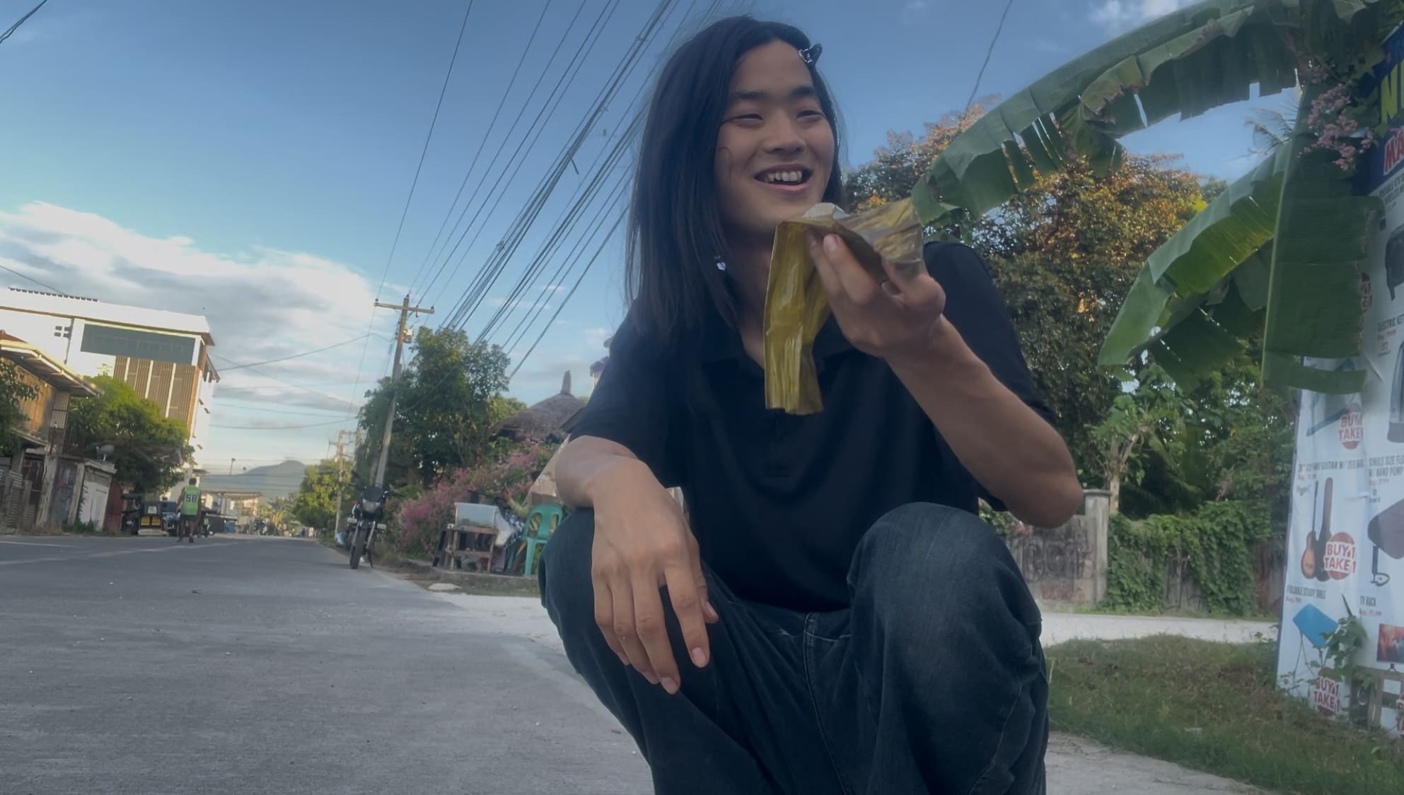 a guy laughing eating budbud pilit in Argao, Cebu