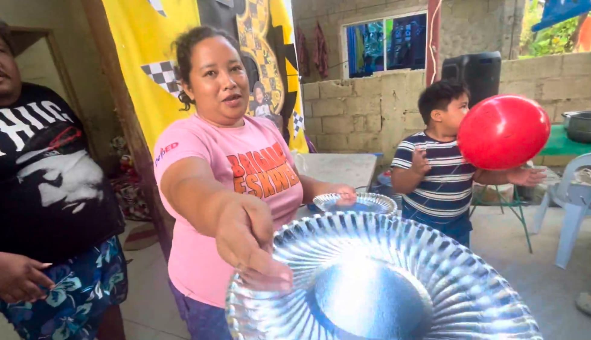 a woman handing a plastic plate.