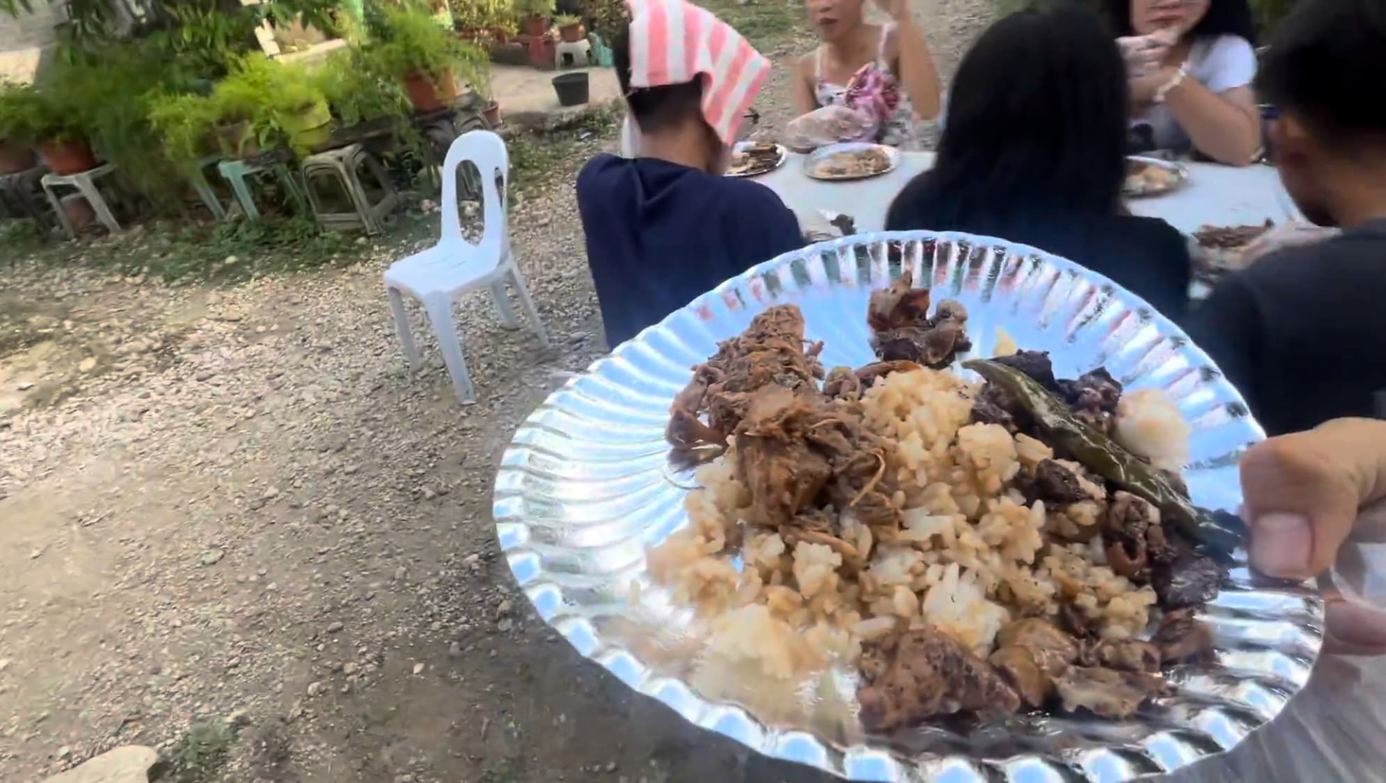 taking a plastic plate to a table.