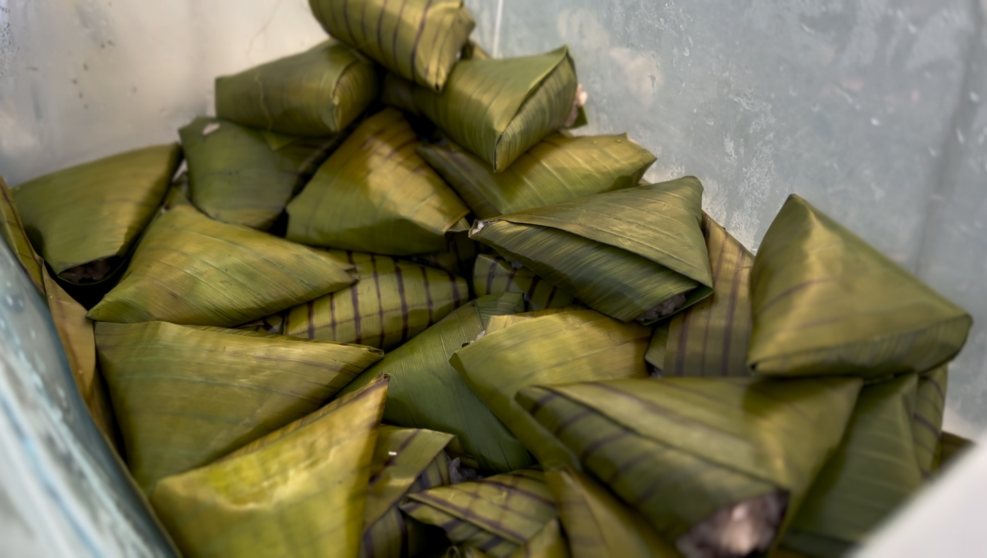 Takumi Senpai eating puto maya with sikwate at a roadside vendor in Argao, Cebu