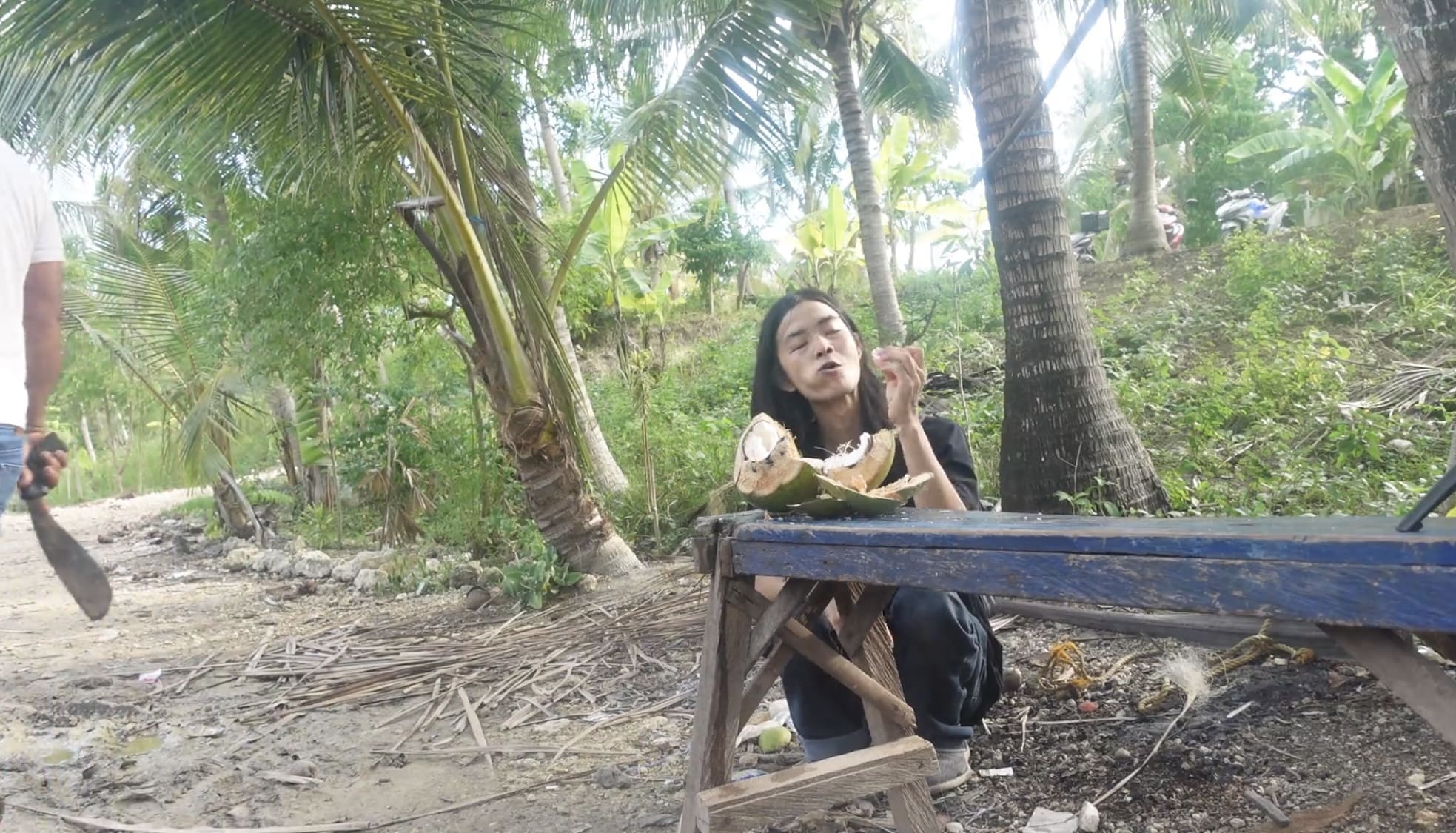 a guy eating coconut meat in Argao