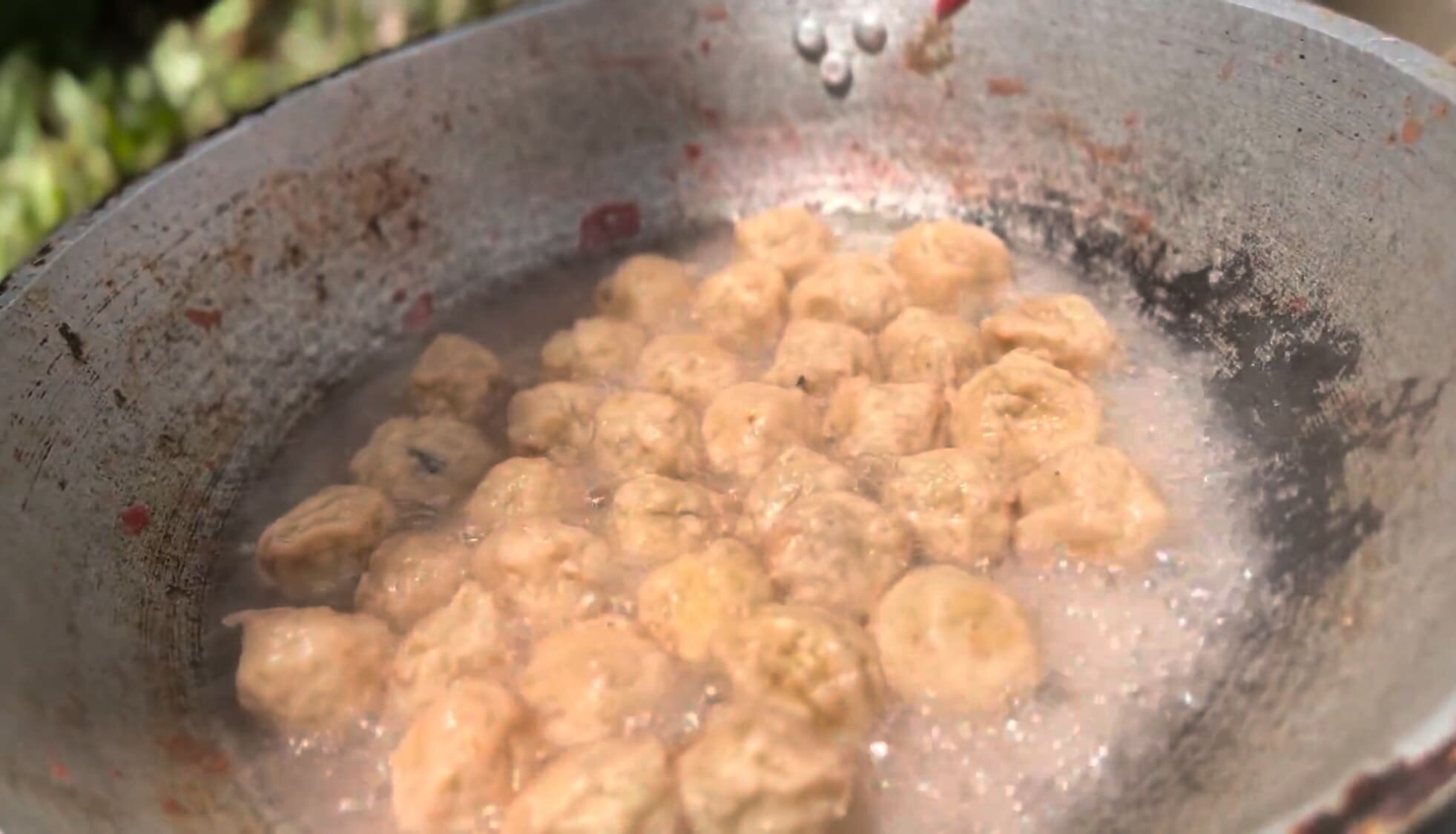 Fish balls cooking in a pan of water, not oil at Coal Mountain Resort, Argao
