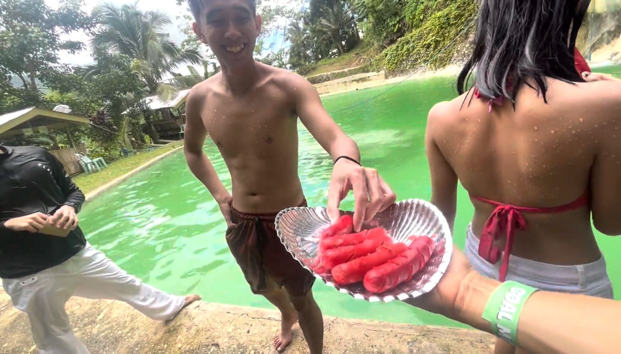 a guy handing hotdog to strangers at Coal Mountain Resort, Argao