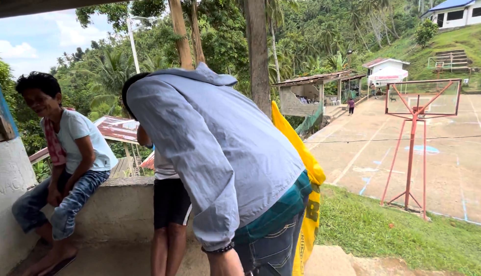 Man doing the Filipino mano gesture with a farmer in Barangay Amancion, Catmon, Cebu