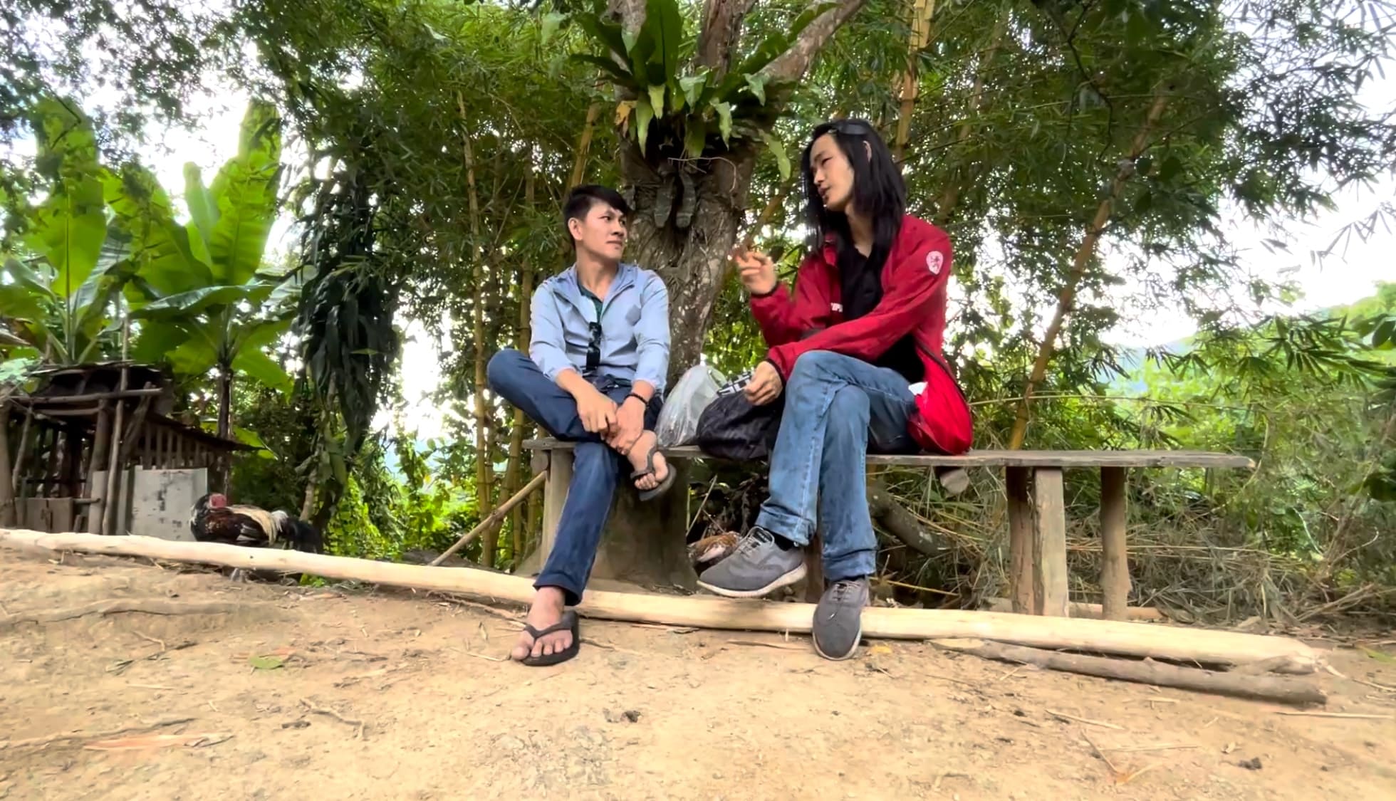 Two men talking on a bench in the mountains of Amancion, Catmon, Cebu