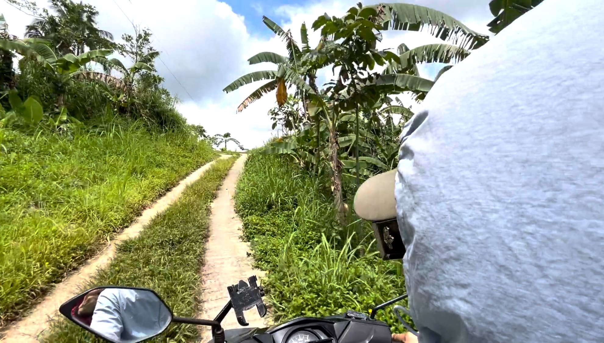 Man riding a motorcycle along a mountain road in Catmon, Cebu