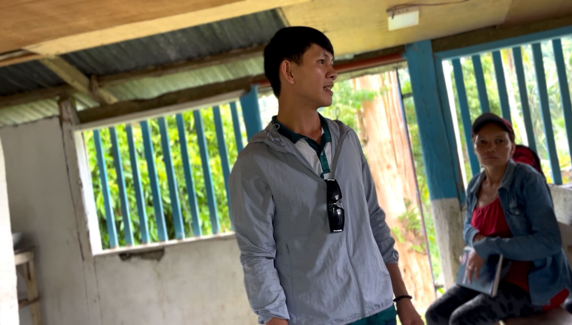 Melvin smiling and talking with local farmers in Cebu, Philippines