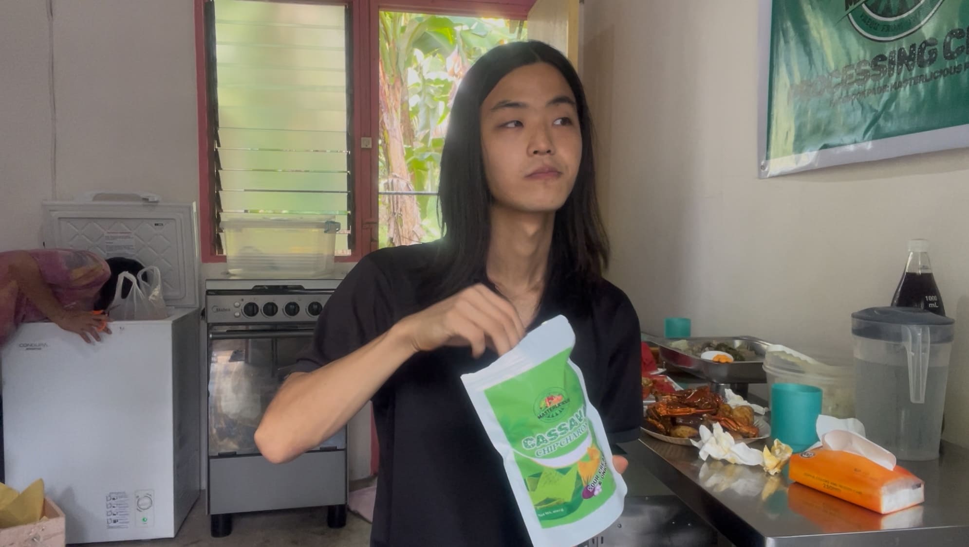 man holding and eating Chip Charon cassava chips