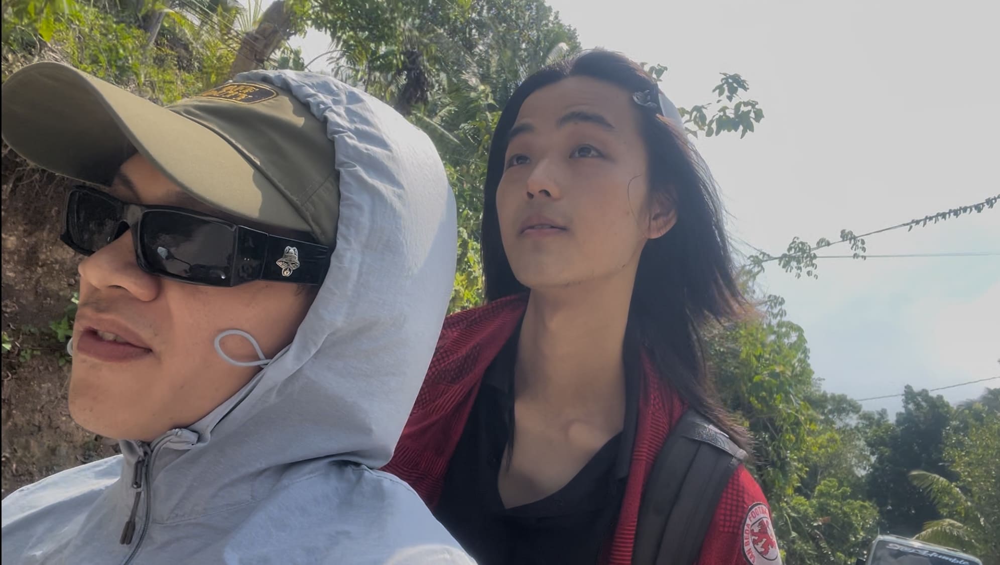 two men riding a motorcycle through the mountains of Catmon Cebu