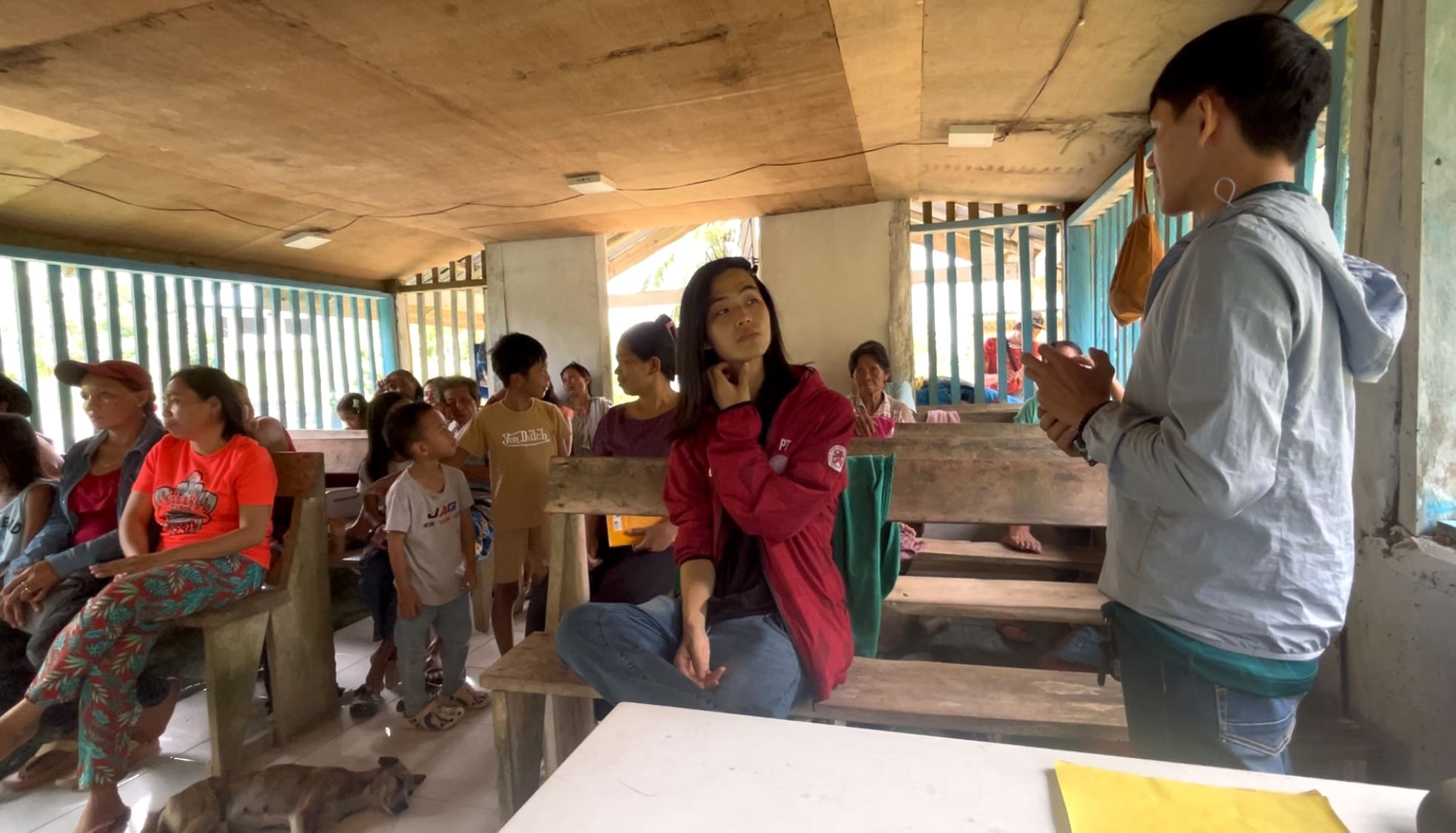 Melvin speaking with farmers during a meeting inside a chapel