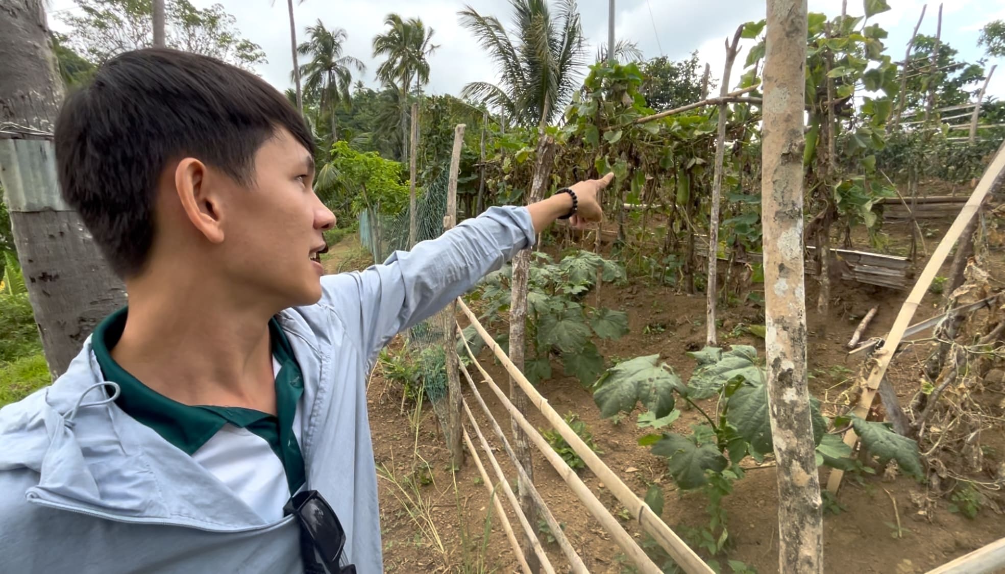 Melvin pointing at the association garden