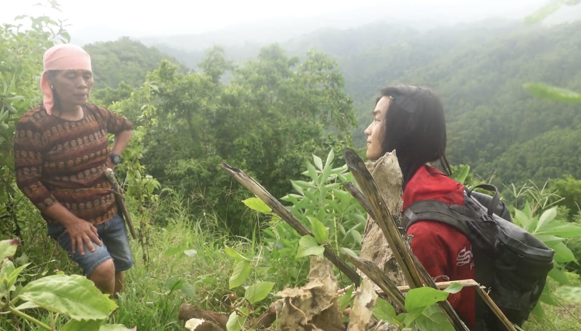 Man talking with a woman on a cassava farm in Barangay Amancion, Catmon