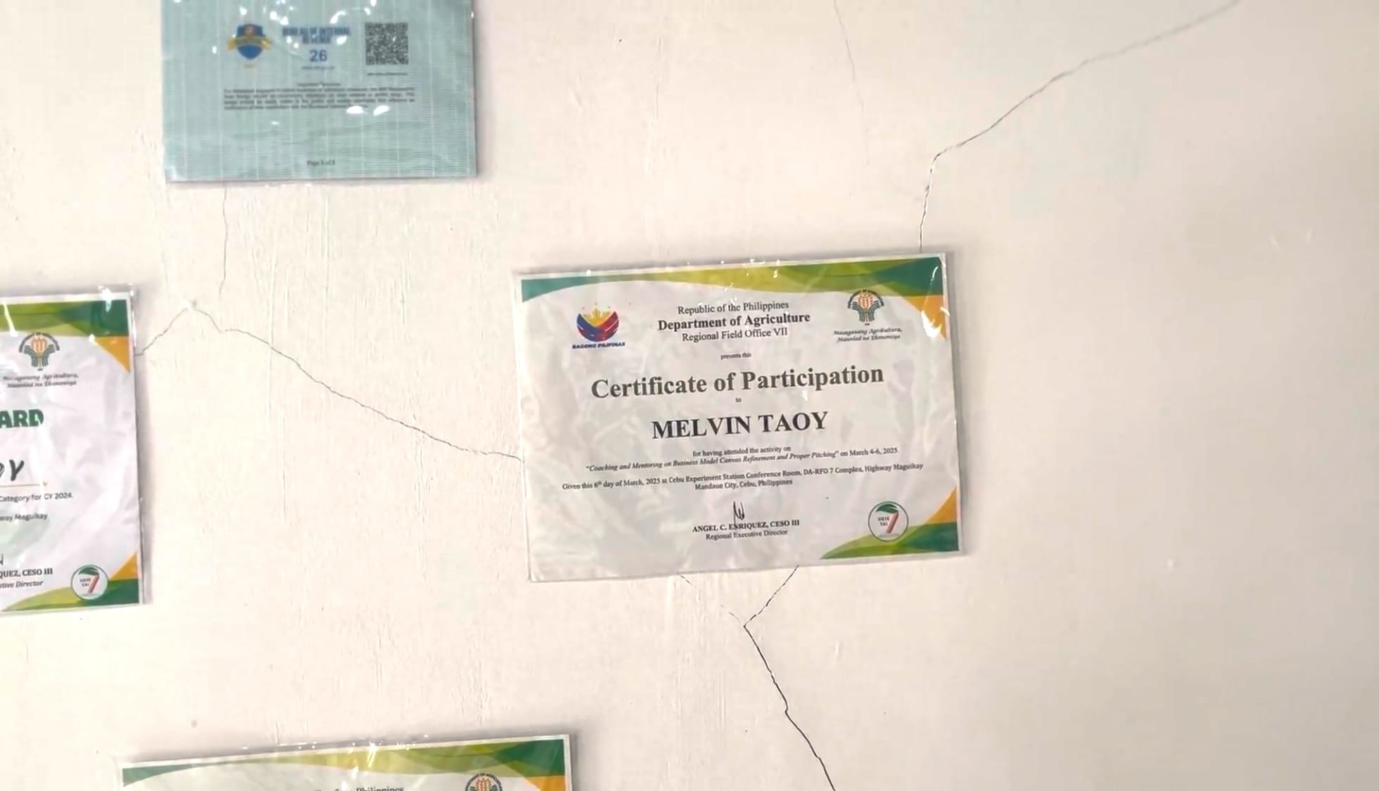 Award certificates displayed on a wall inside a small business facility