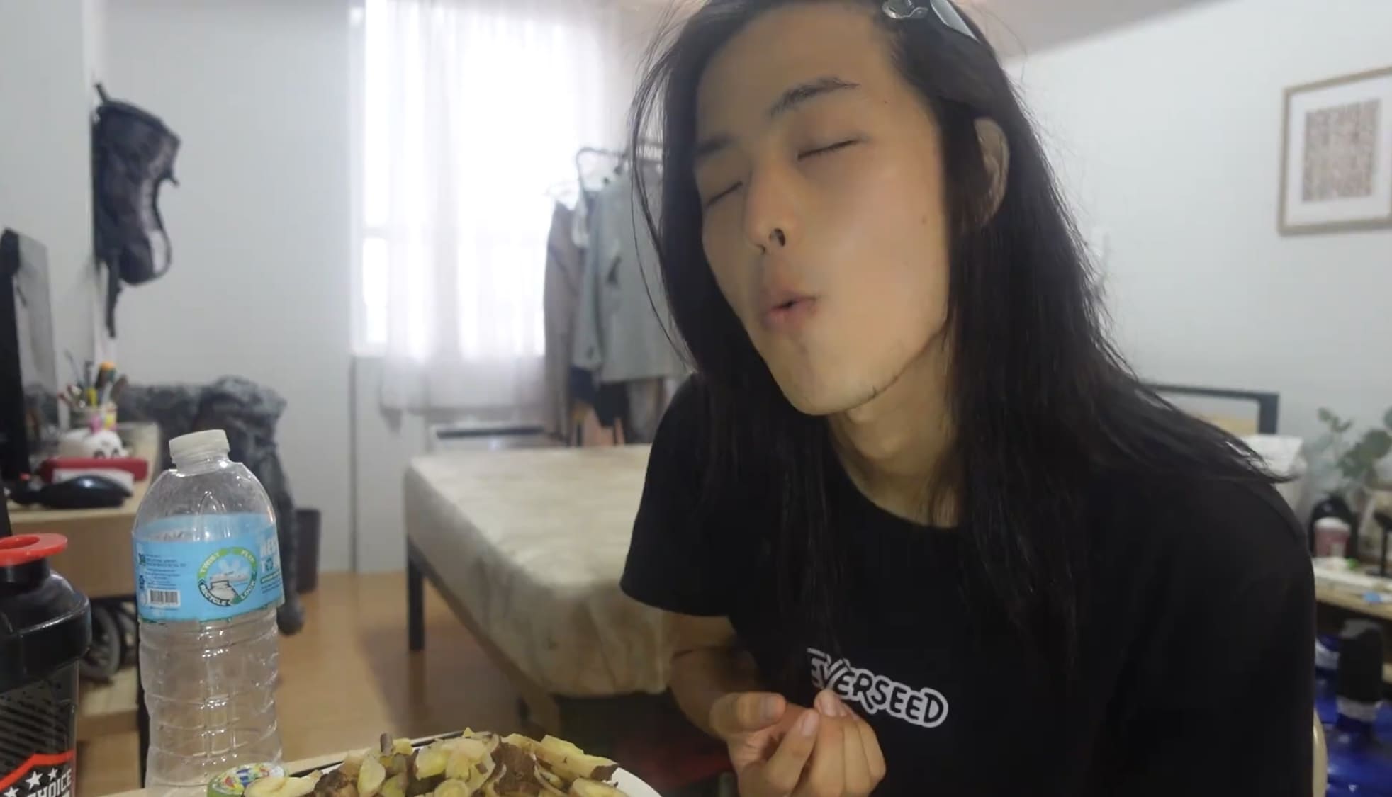 Man eating boiled cassava inside a room after returning from Catmon