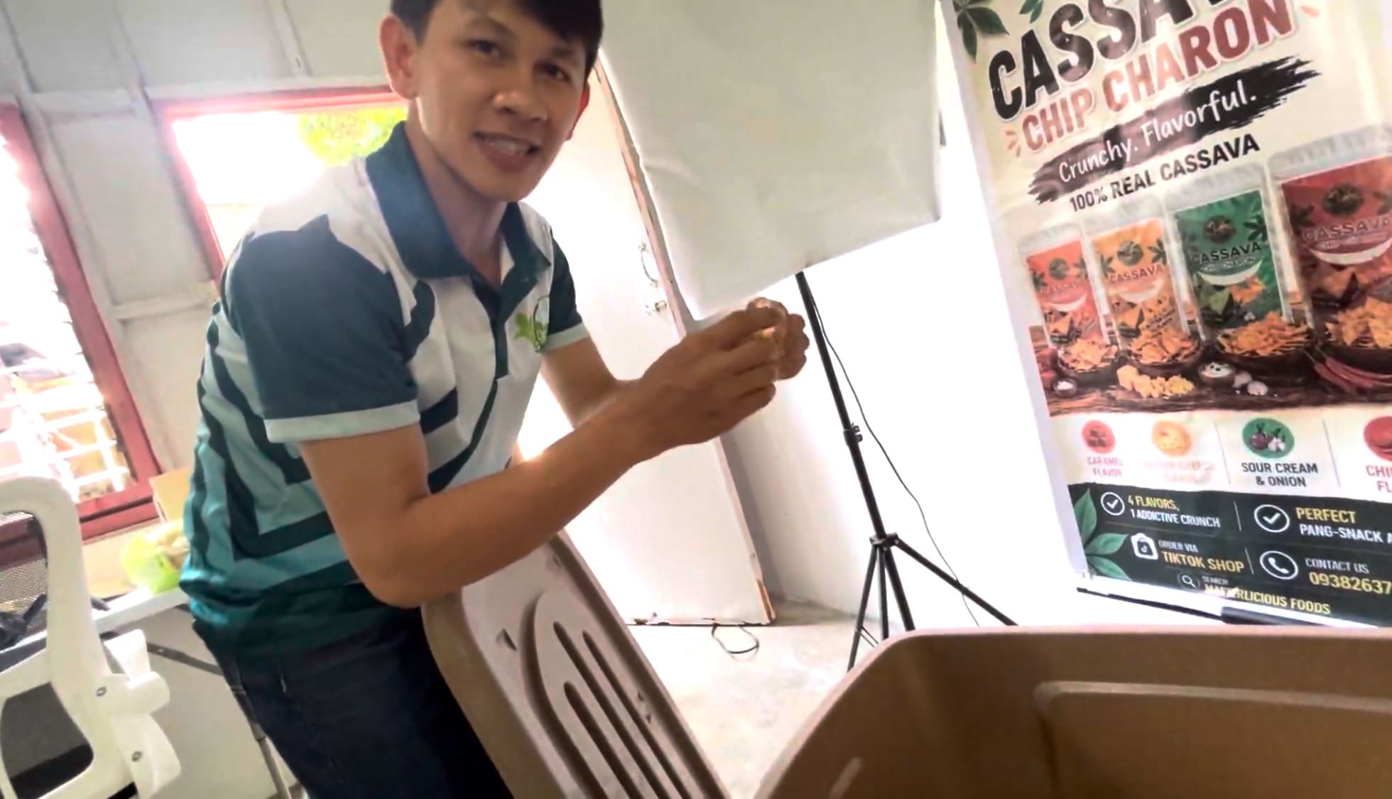Man showing uncooked kamote chips before frying