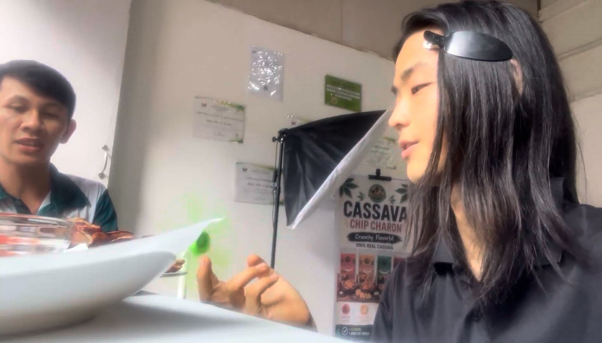 Man tasting kamote chips at a table