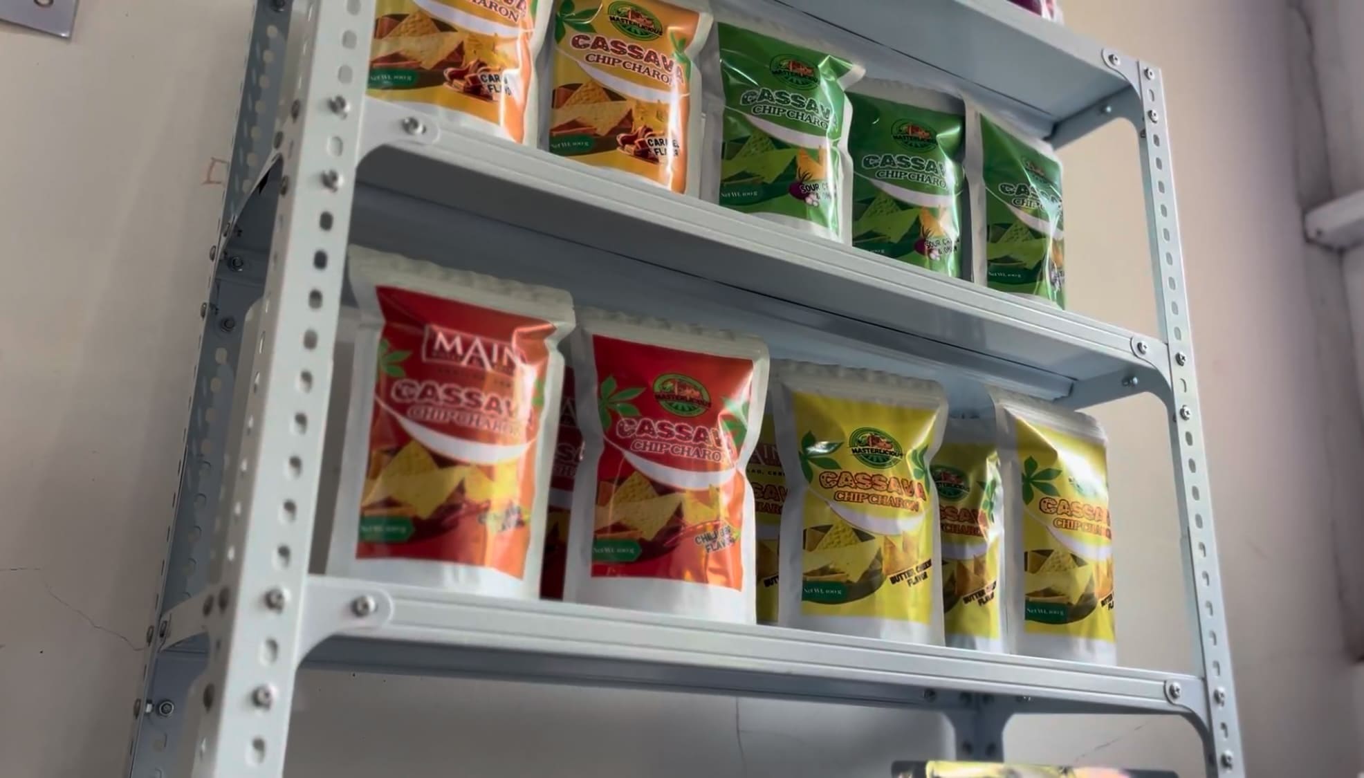 Cassava chips packages arranged on shelves inside a processing facility