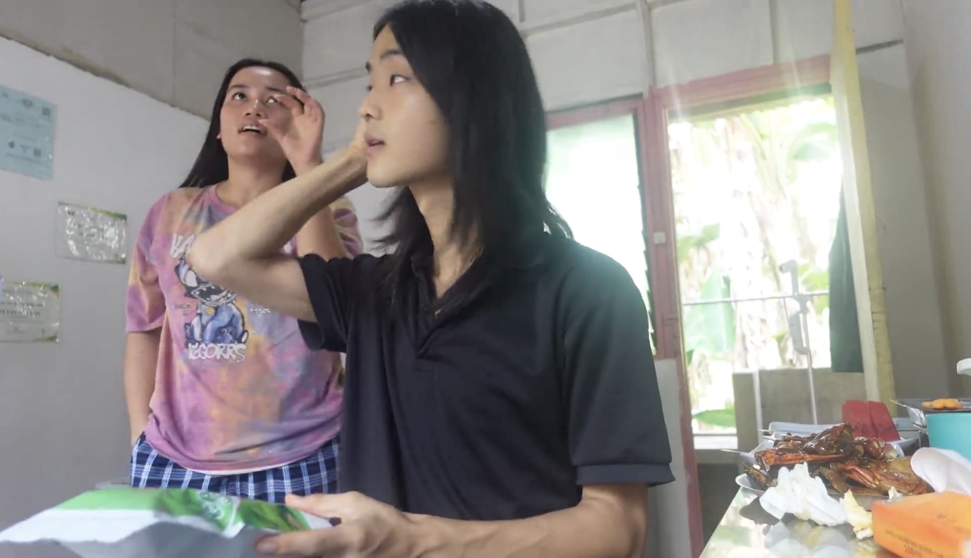 Woman talking while a man turns around and looks back at her