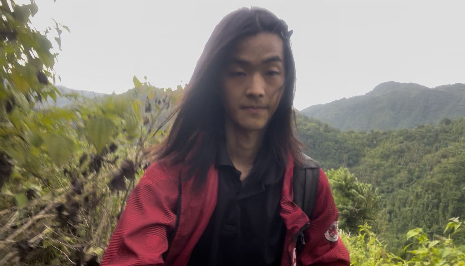 Man standing in a cassava field in the mountains