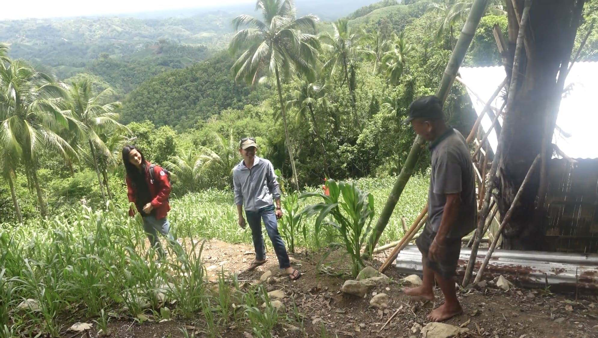 Two men smiling and talking in a kabog field