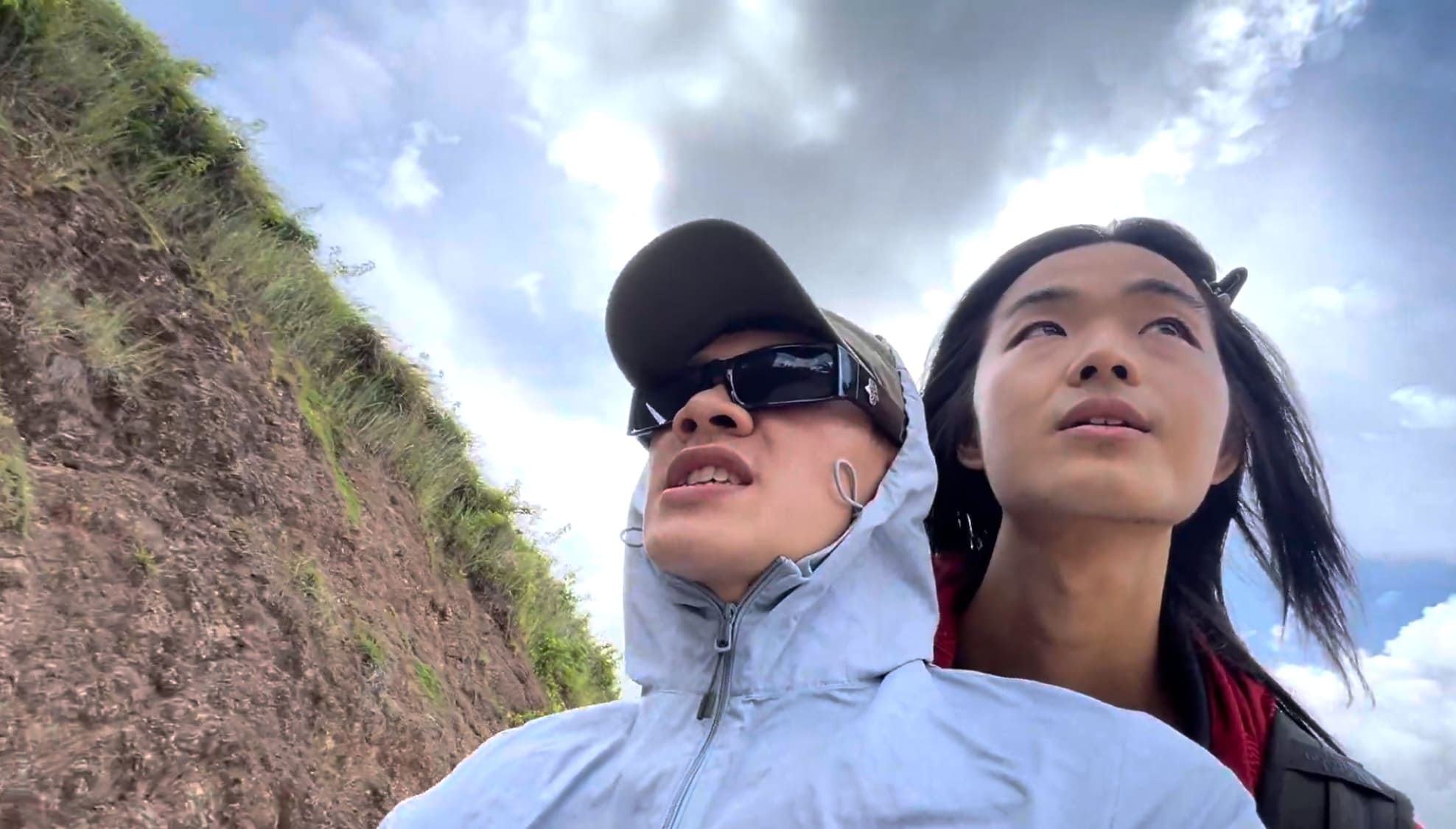 Two men riding a motorcycle on a mountain road in Cebu