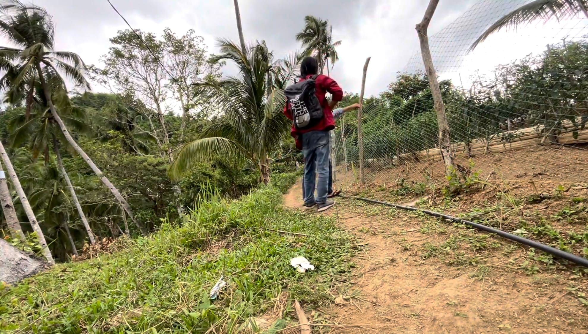 Two men walking near a farm in the mountains of Cebu