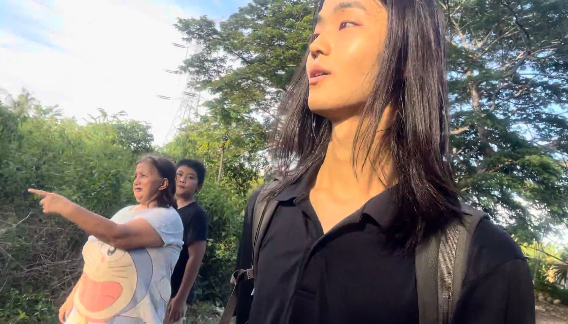 a japaense guy and filipinos walking together in Argao