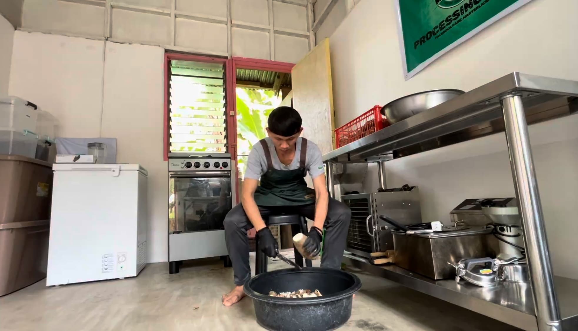 Man peeling cassava during food processing work