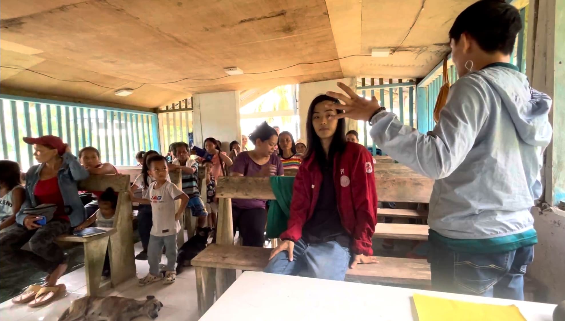 Man explaining something to a group of farmers