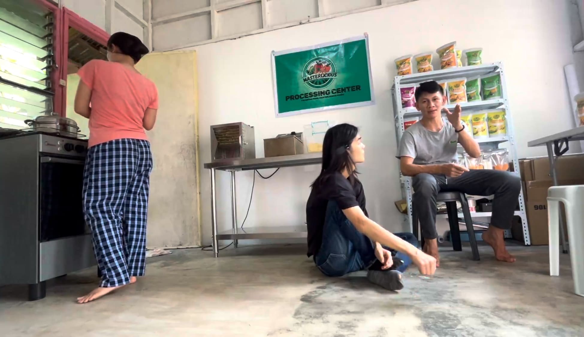 Two men having a serious conversation inside a food processing facility in Catmon