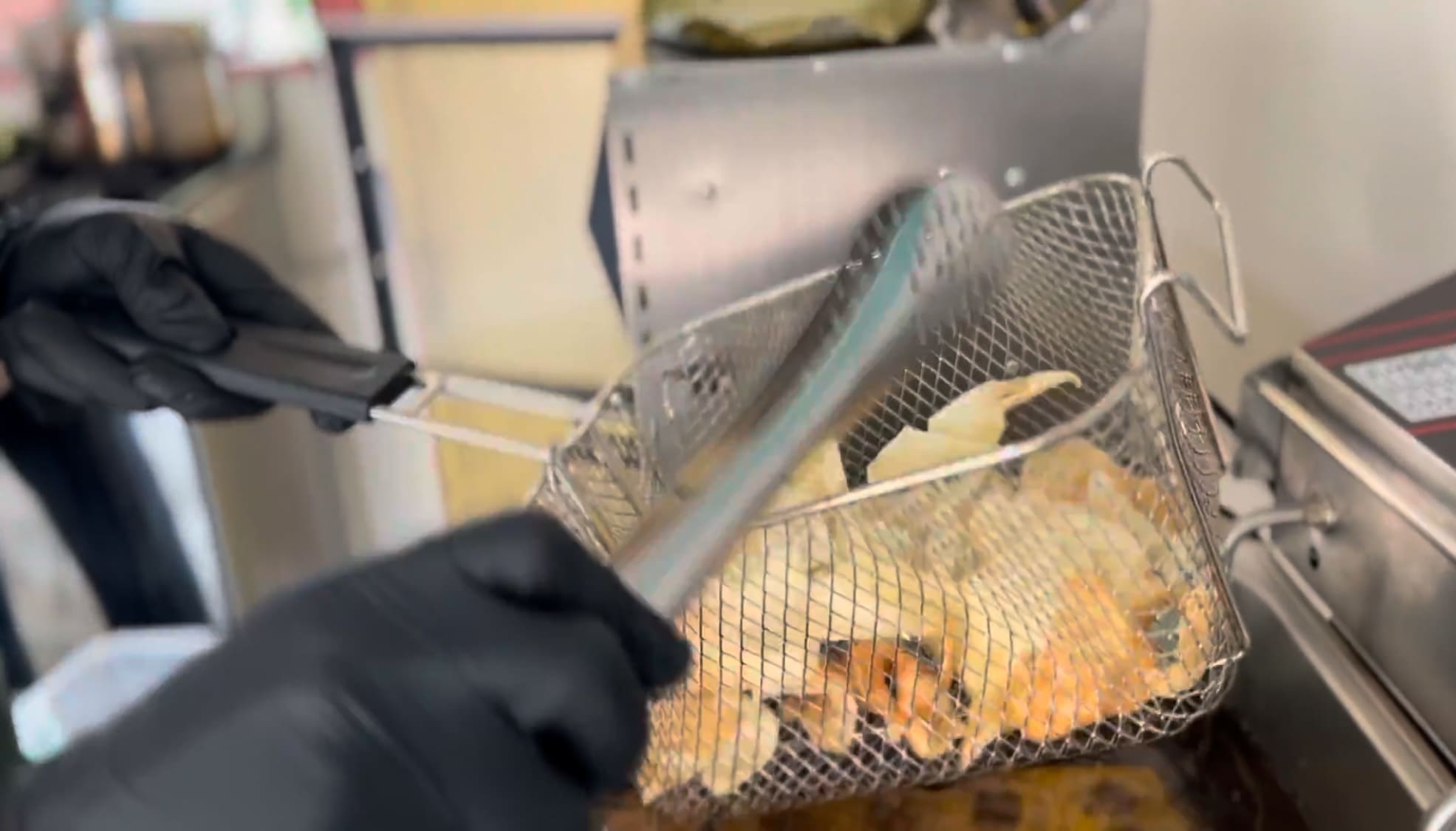 Man frying cassava chips during food processing