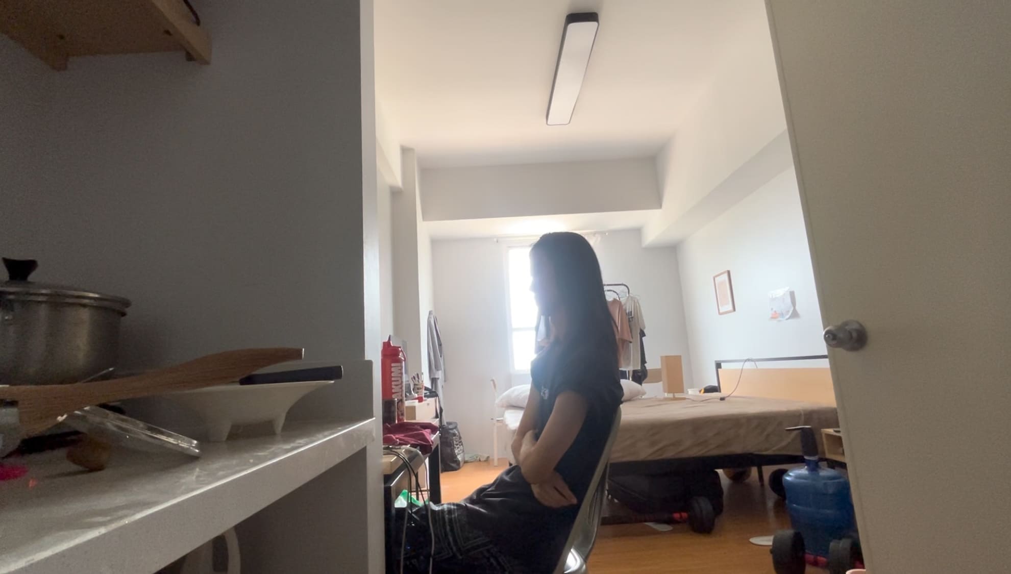 Man sitting in a room looking out at IT Park after returning from a rural area