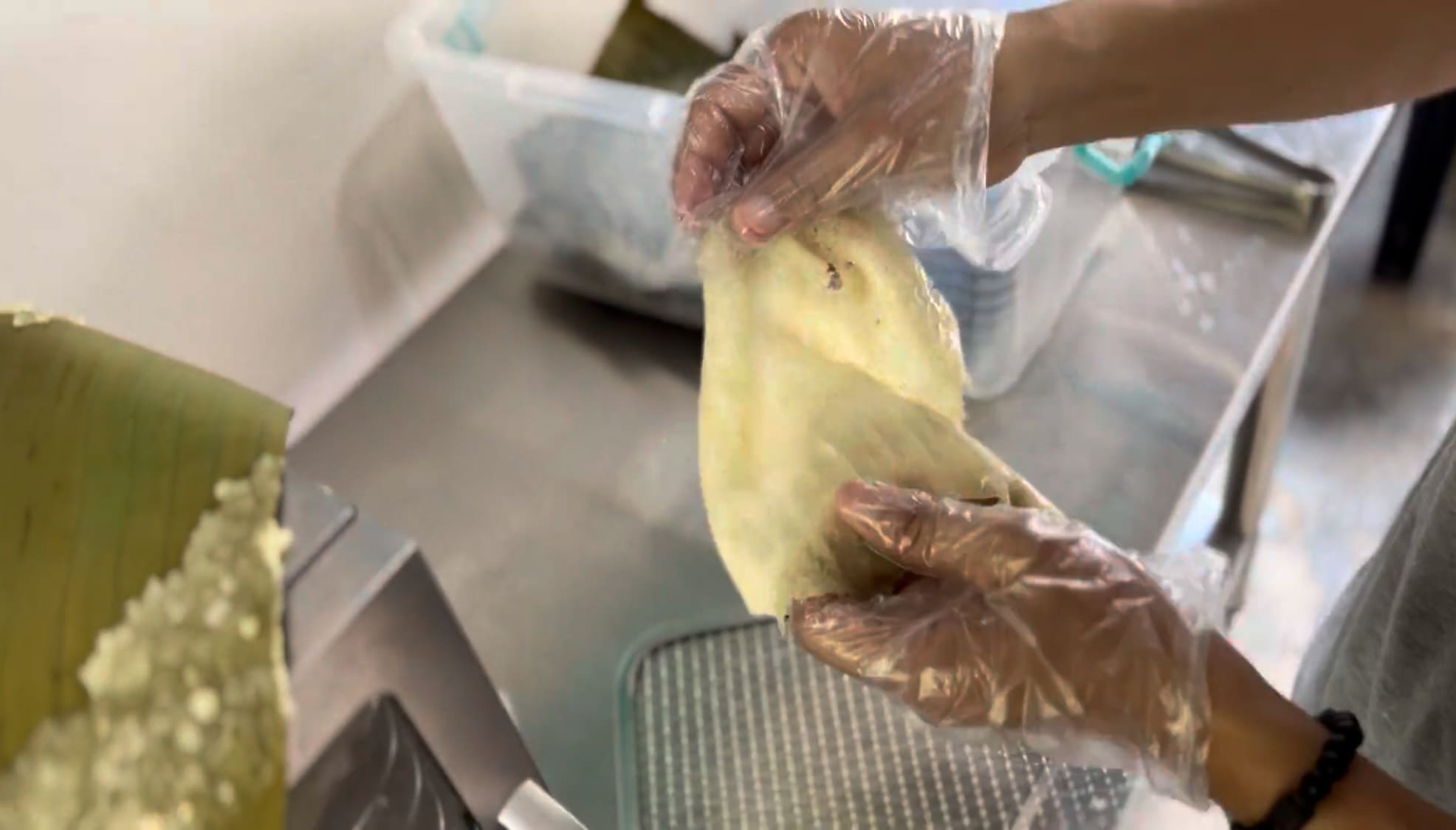 Man checking the texture of dehydrated cassava chips by hand