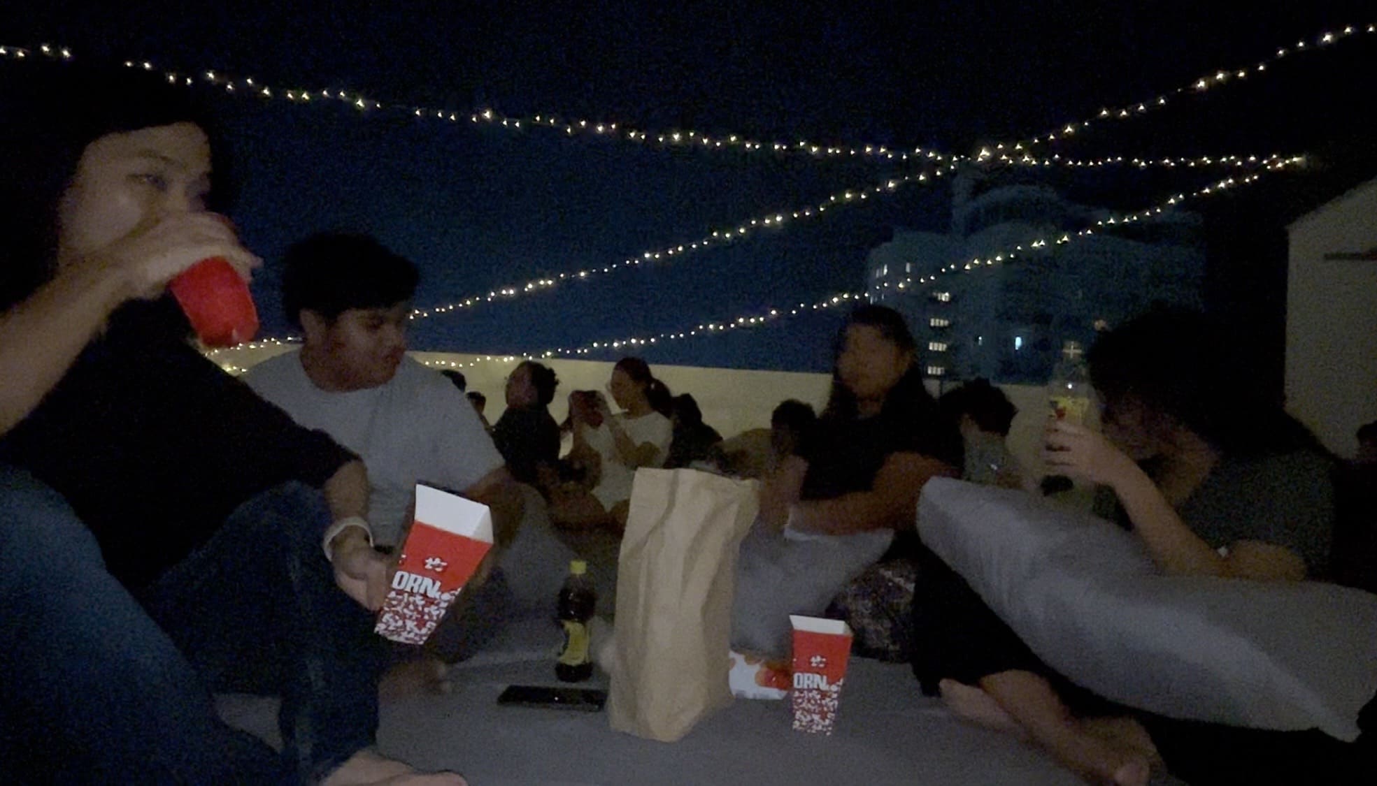 Two men and two women relaxing together on a rooftop deck in Cebu