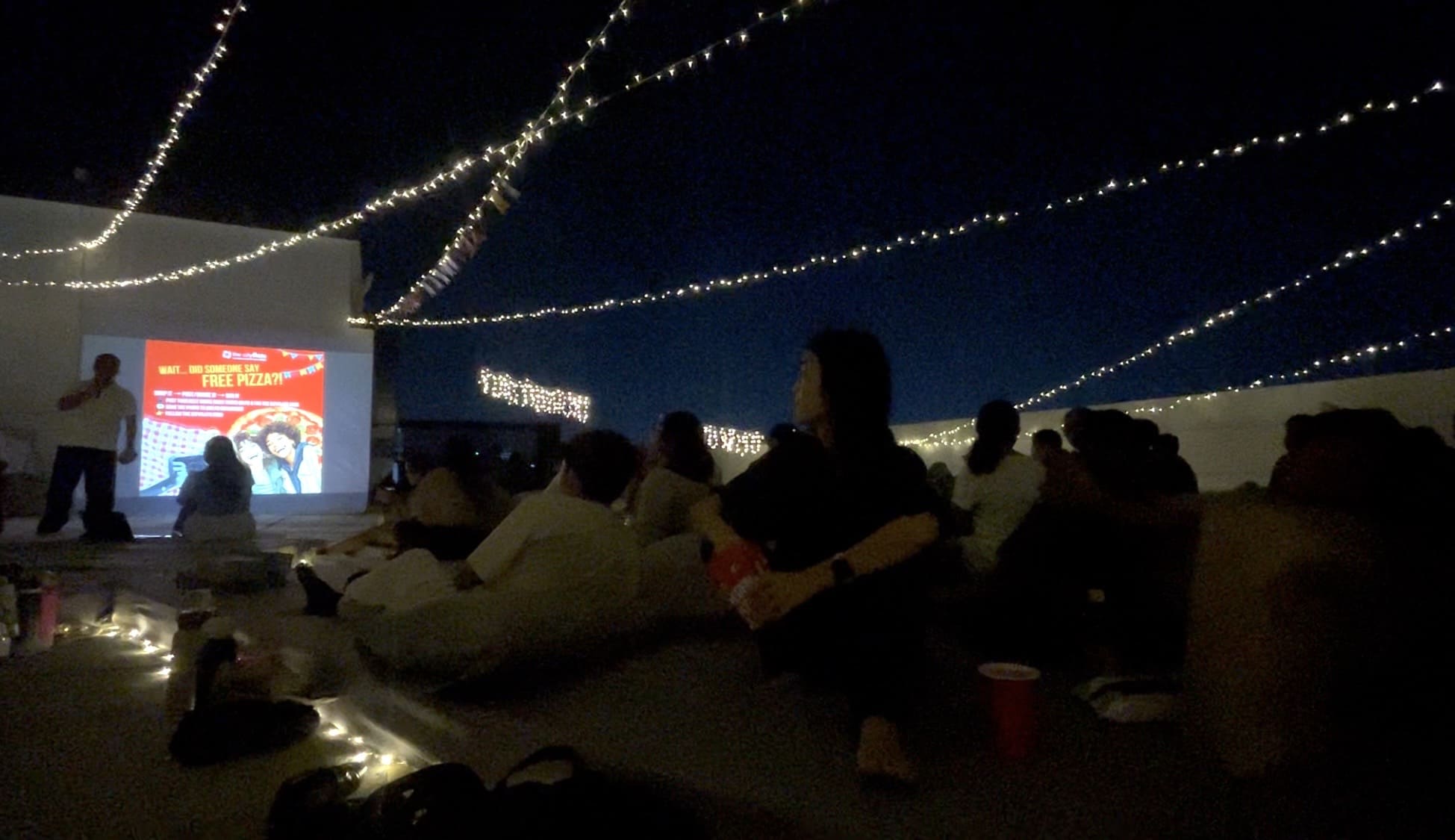 People enjoying a Cinema Night together on a rooftop deck in Cebu