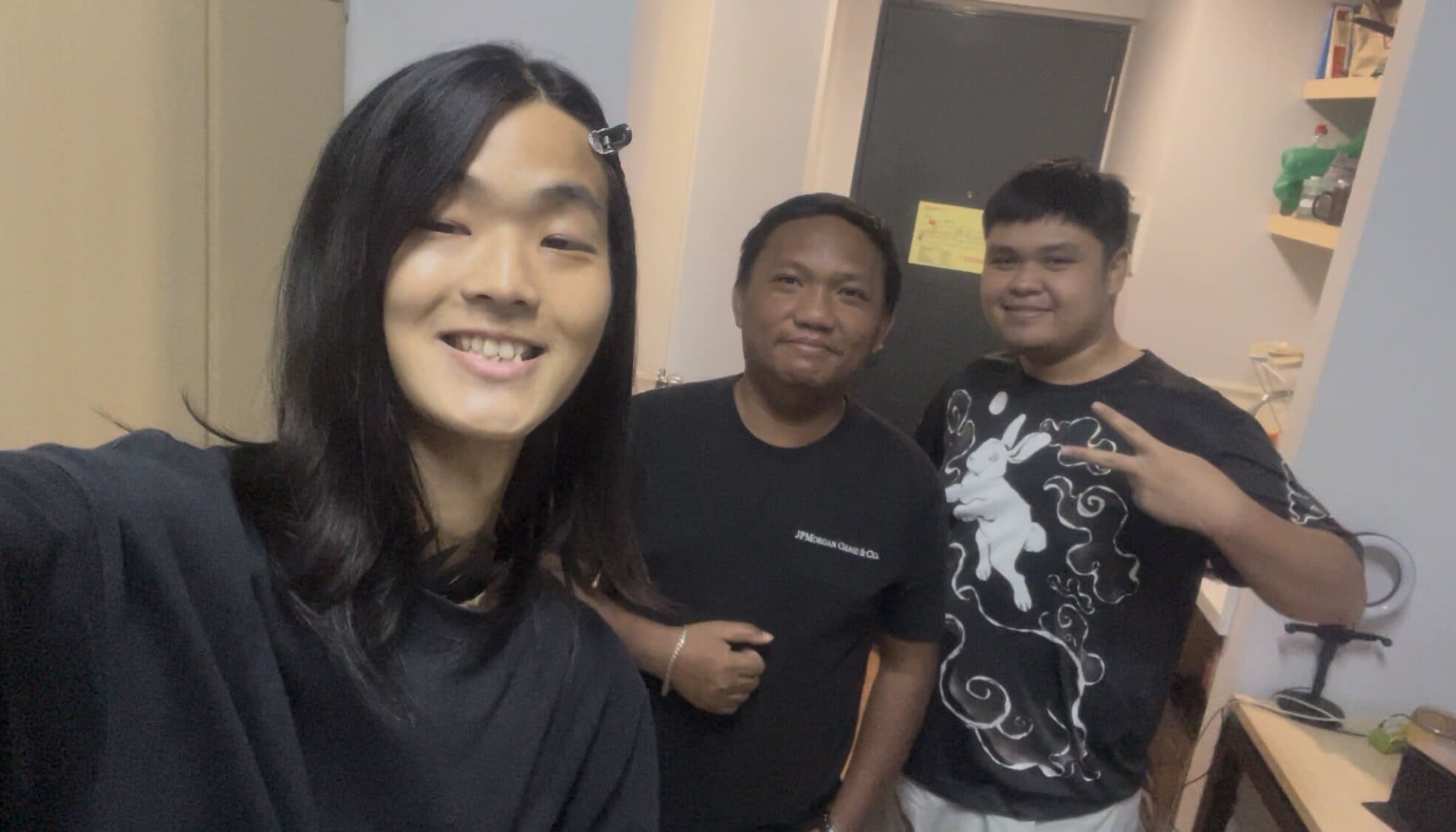 Three men smiling for a group photo