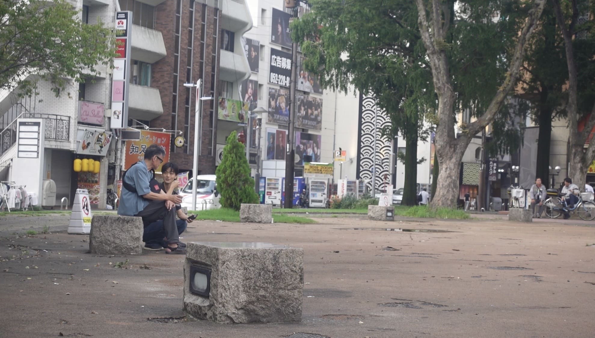 Two men talking together in a park