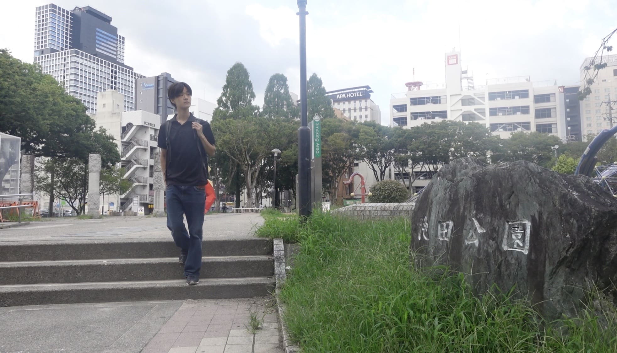 A man walking away from Ikeda Park