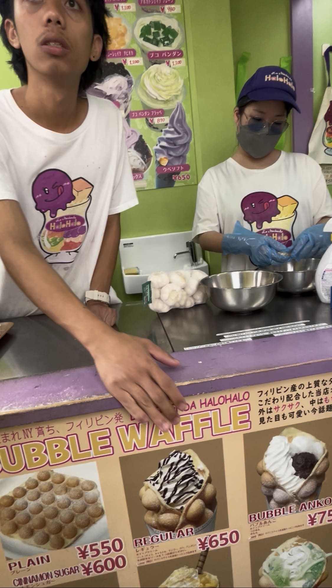 Filipino male staff member pointing at a waffle menu