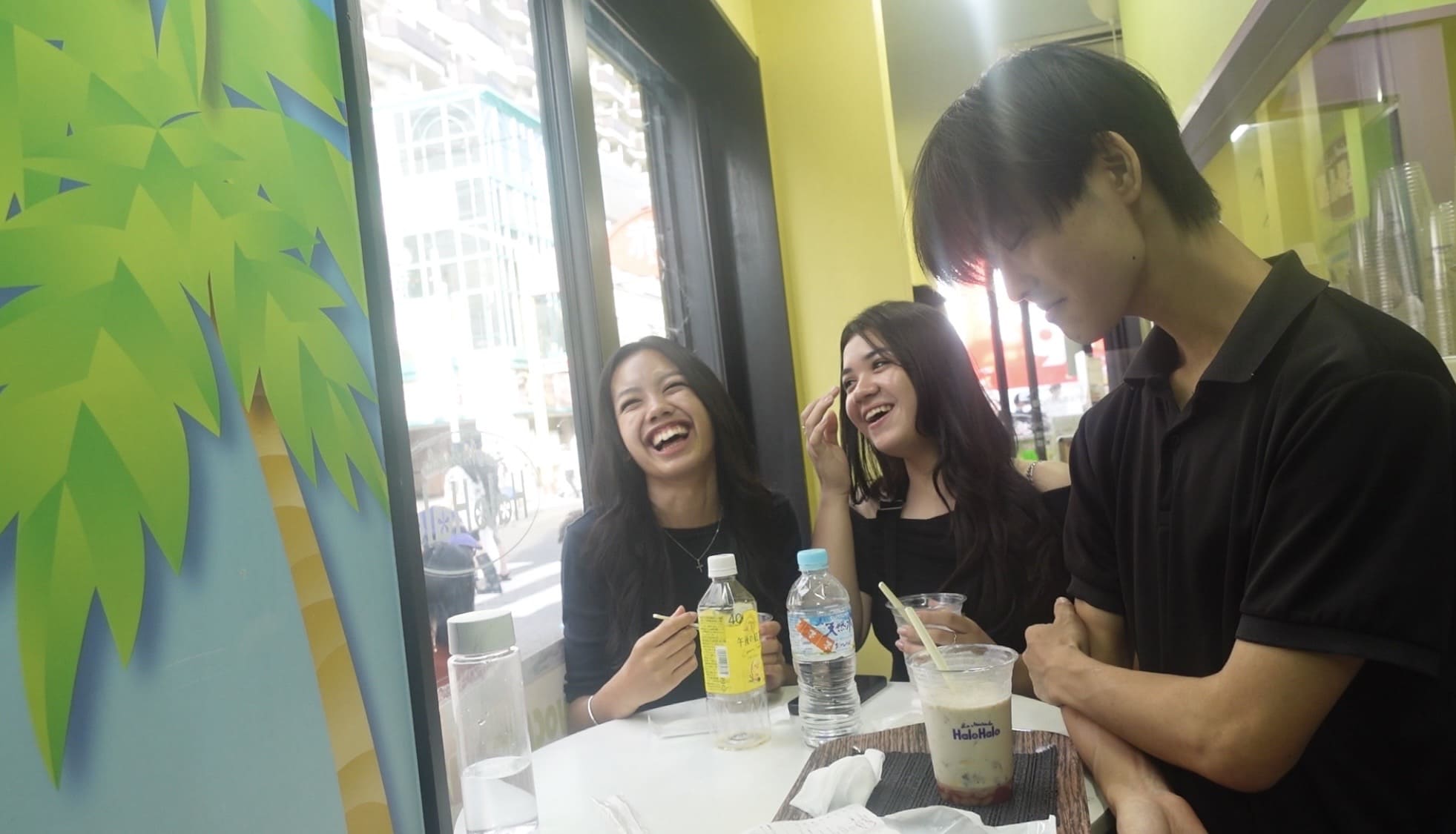 Man talking and laughing with Filipino customers at a restaurant