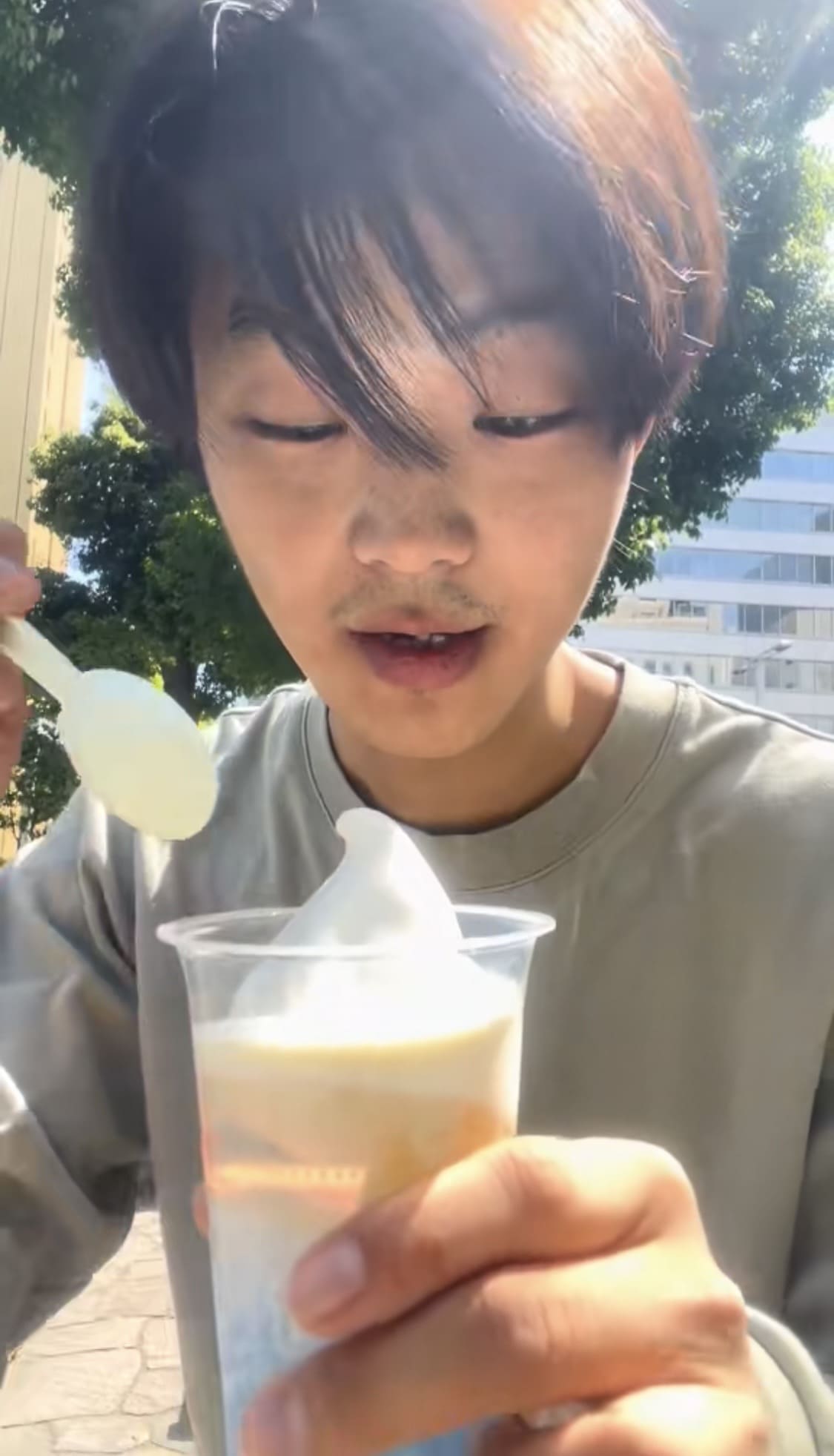 Man eating a halo-halo dessert at a Japanese convenience store