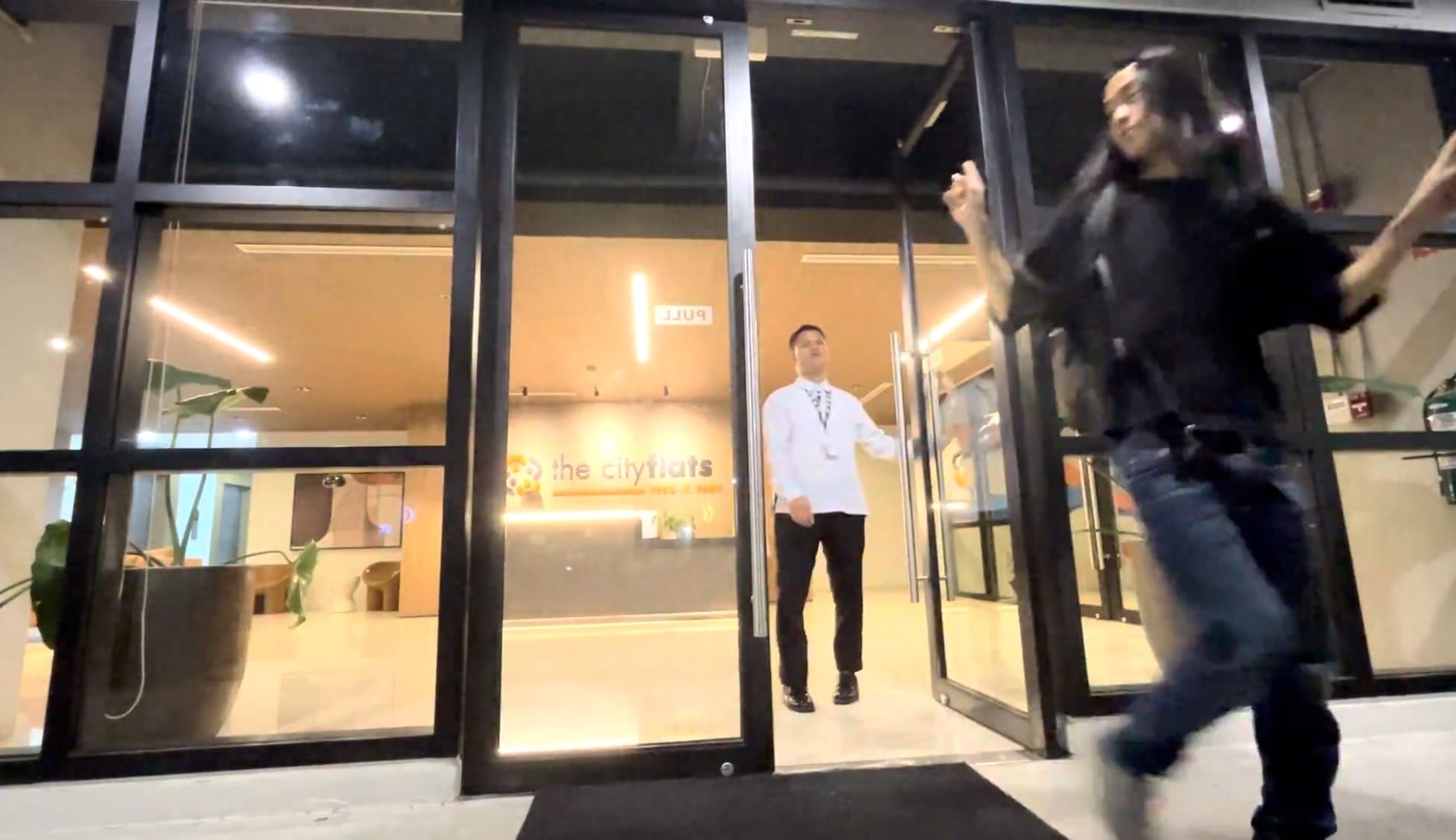Man opening the door at a hotel lobby in Cebu at night
