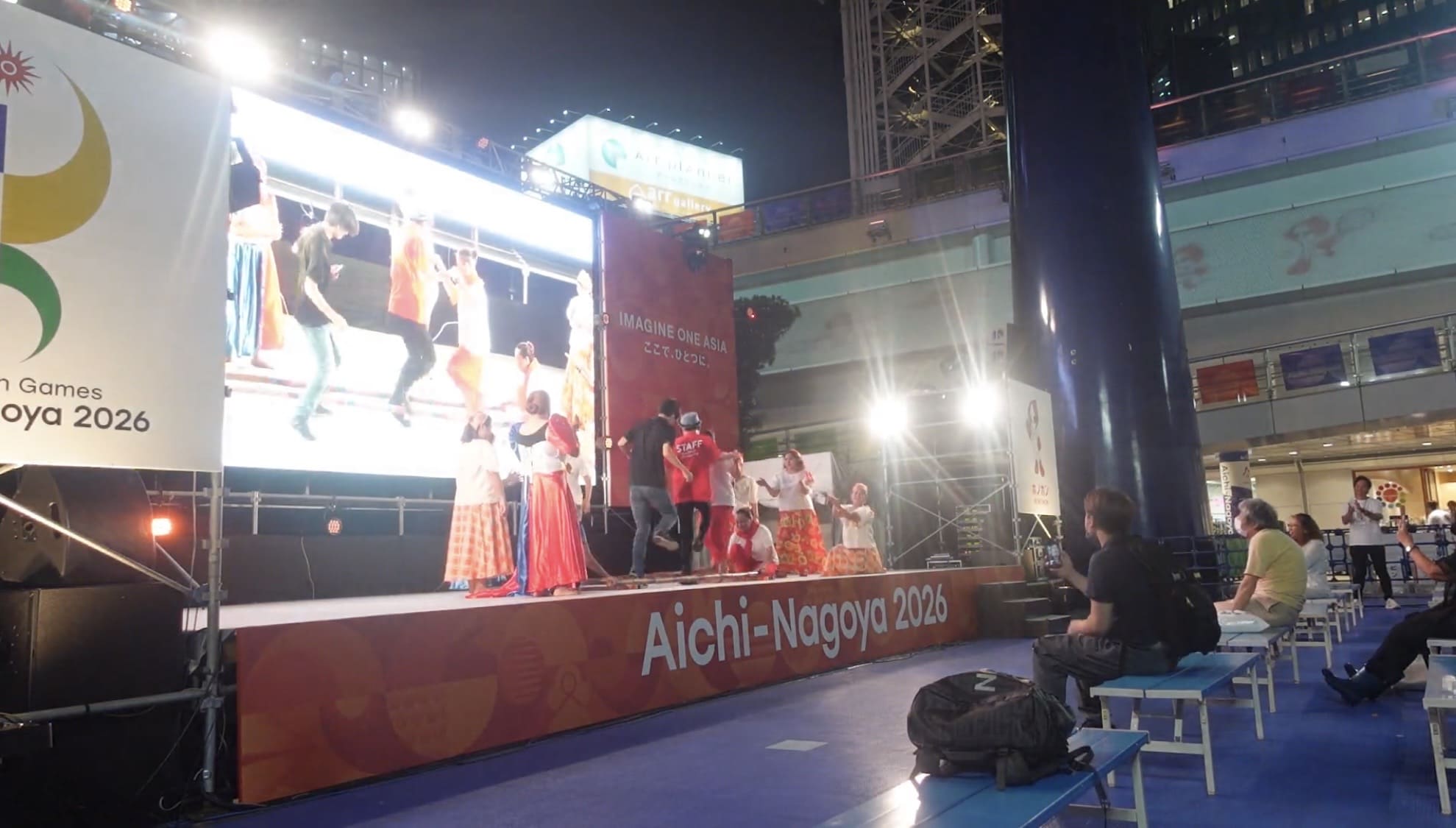 Man joining Filipino performers in a bamboo dance at Oasis 21