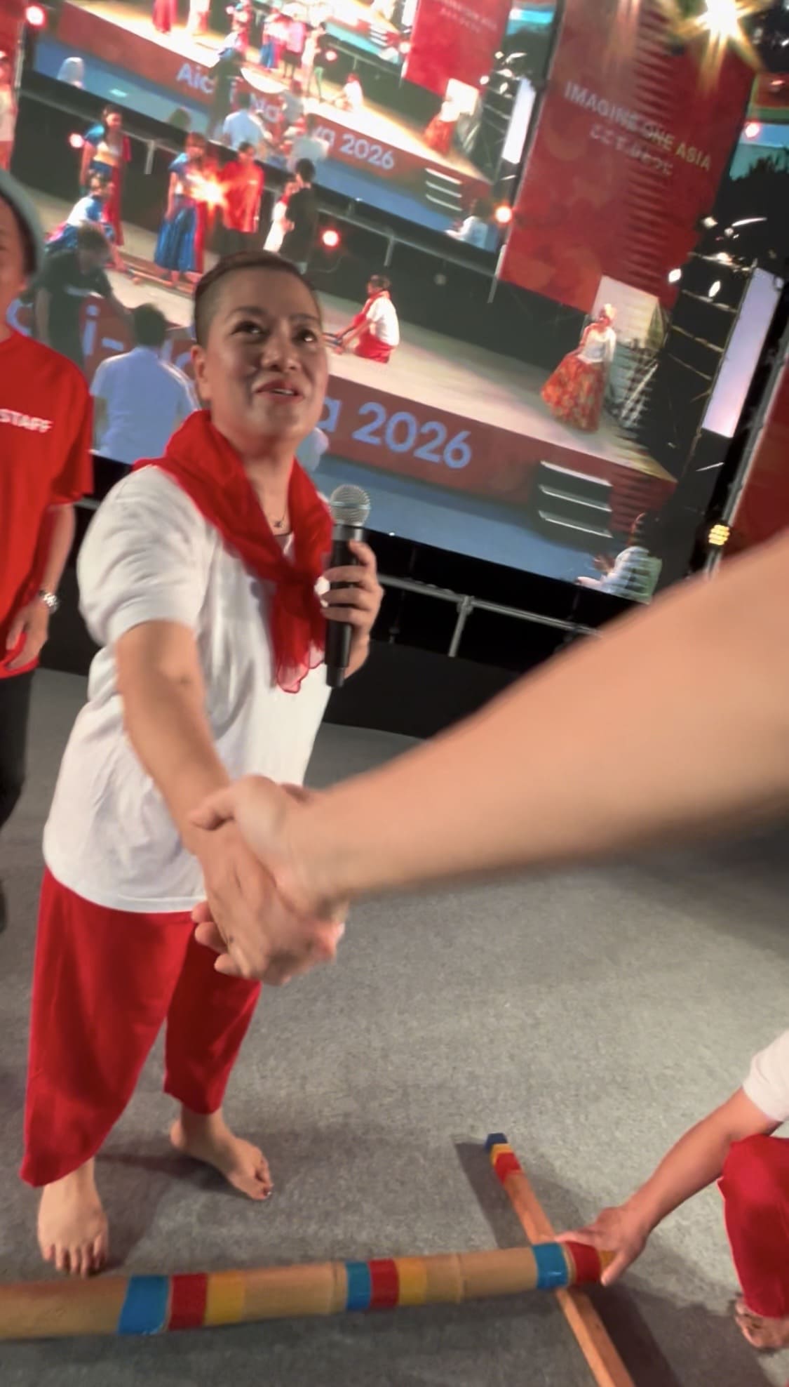 Man talking and shaking hands with a Filipina performer at Oasis 21