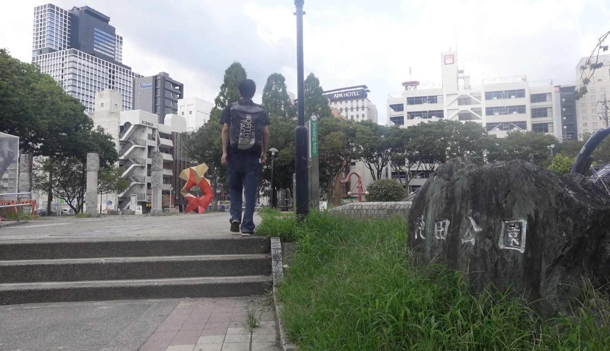 Man walking into Ikeda Park in Nagoya at night
