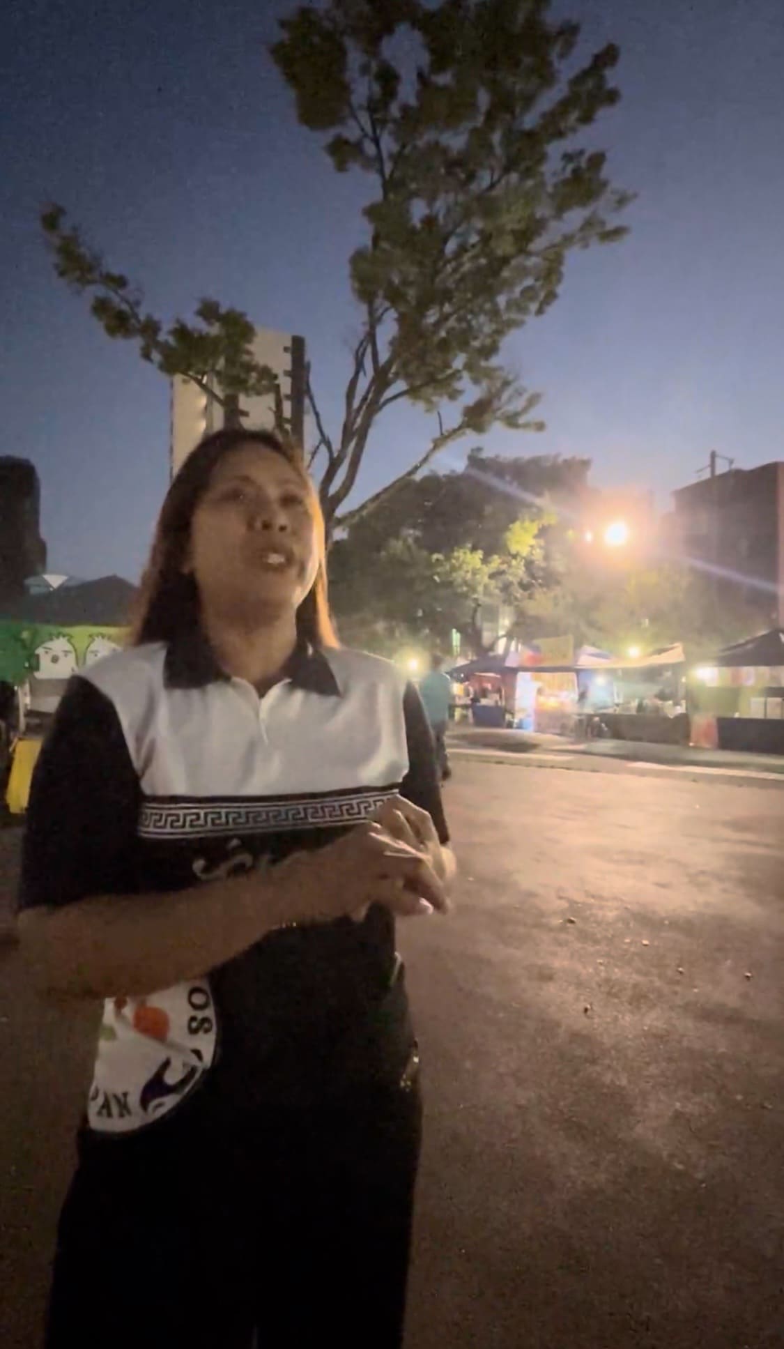 A woman speaking seriously during an interview in a park