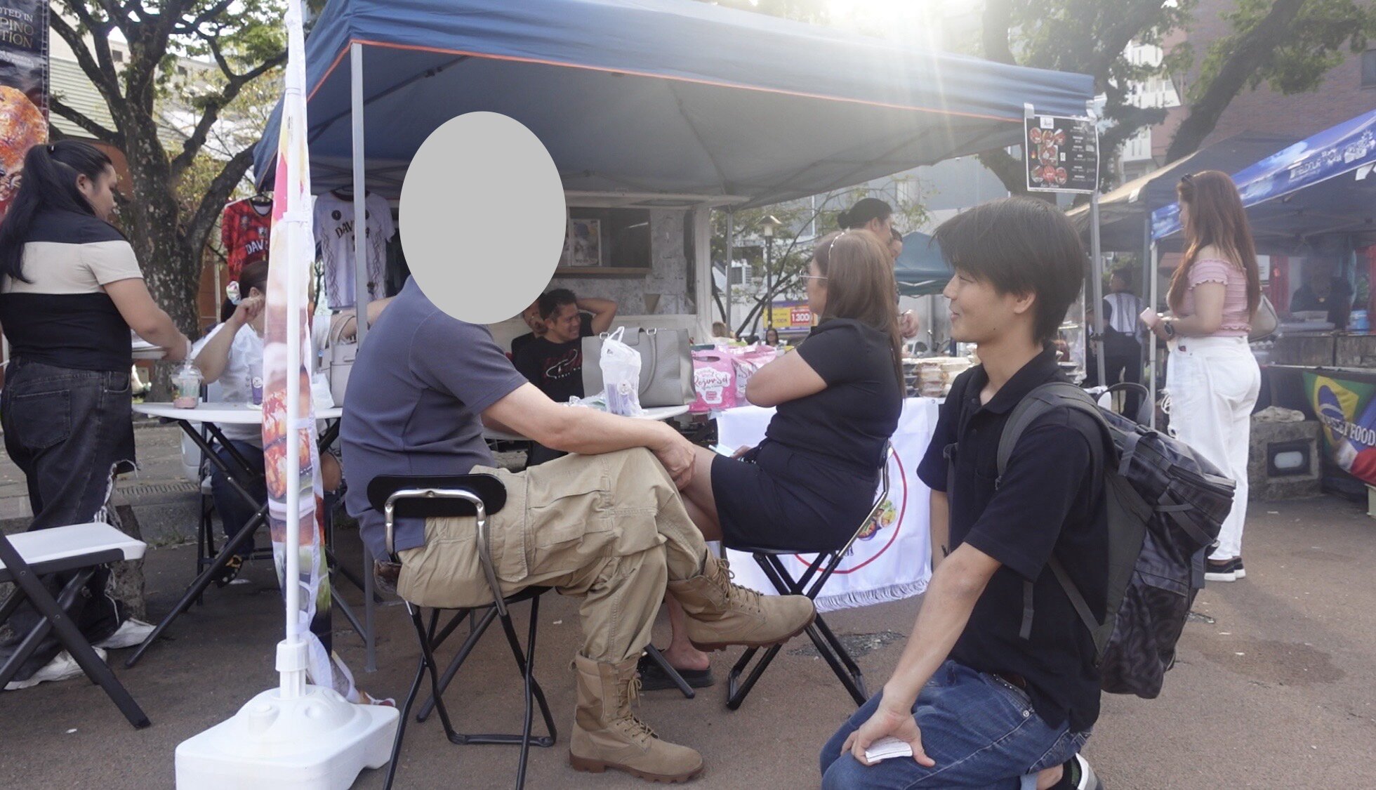 Two men talking during a street interview about language and cultural differences in Japan