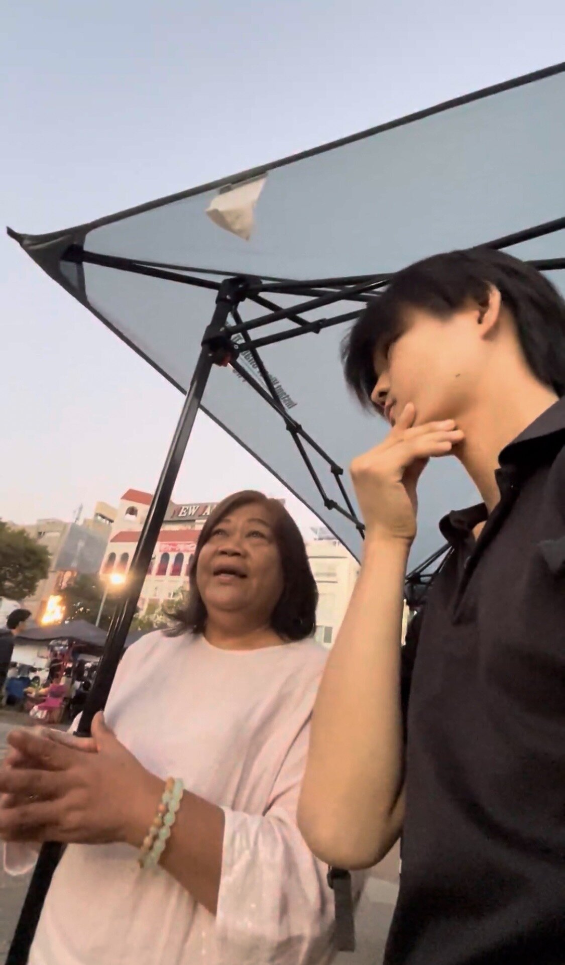 A man listening to a woman during a conversation about Filipino life in Japan