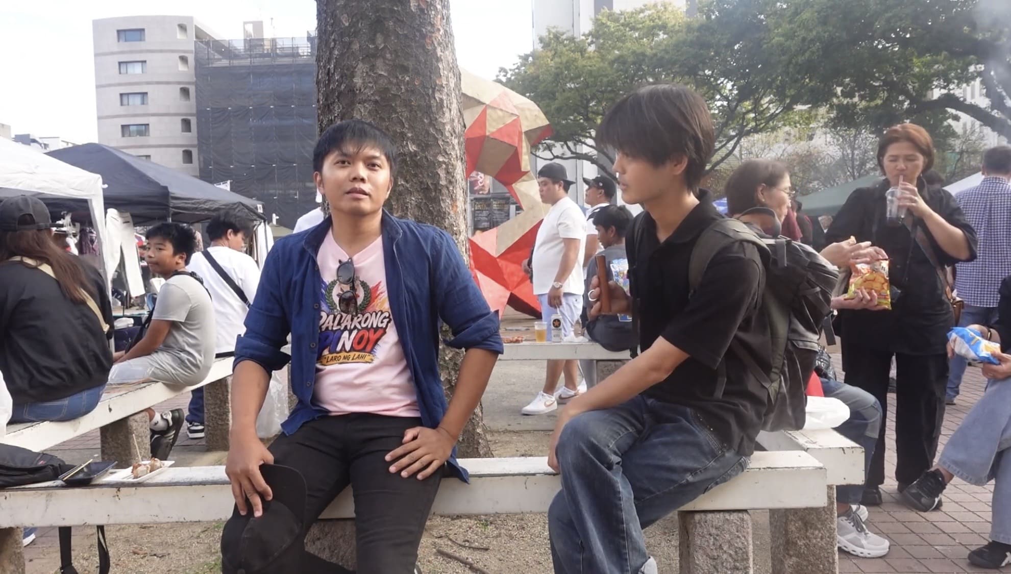 Filipino man talking with a Japanese man during an interview
